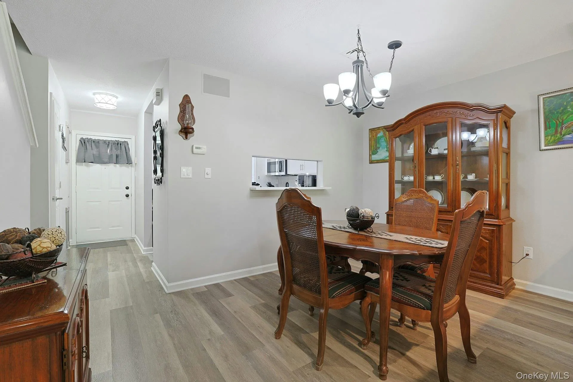 view from the dining room towards the entry foyer and pass through to the kitchen view from the dining room towards the entry foyer and pass through to the kitchen