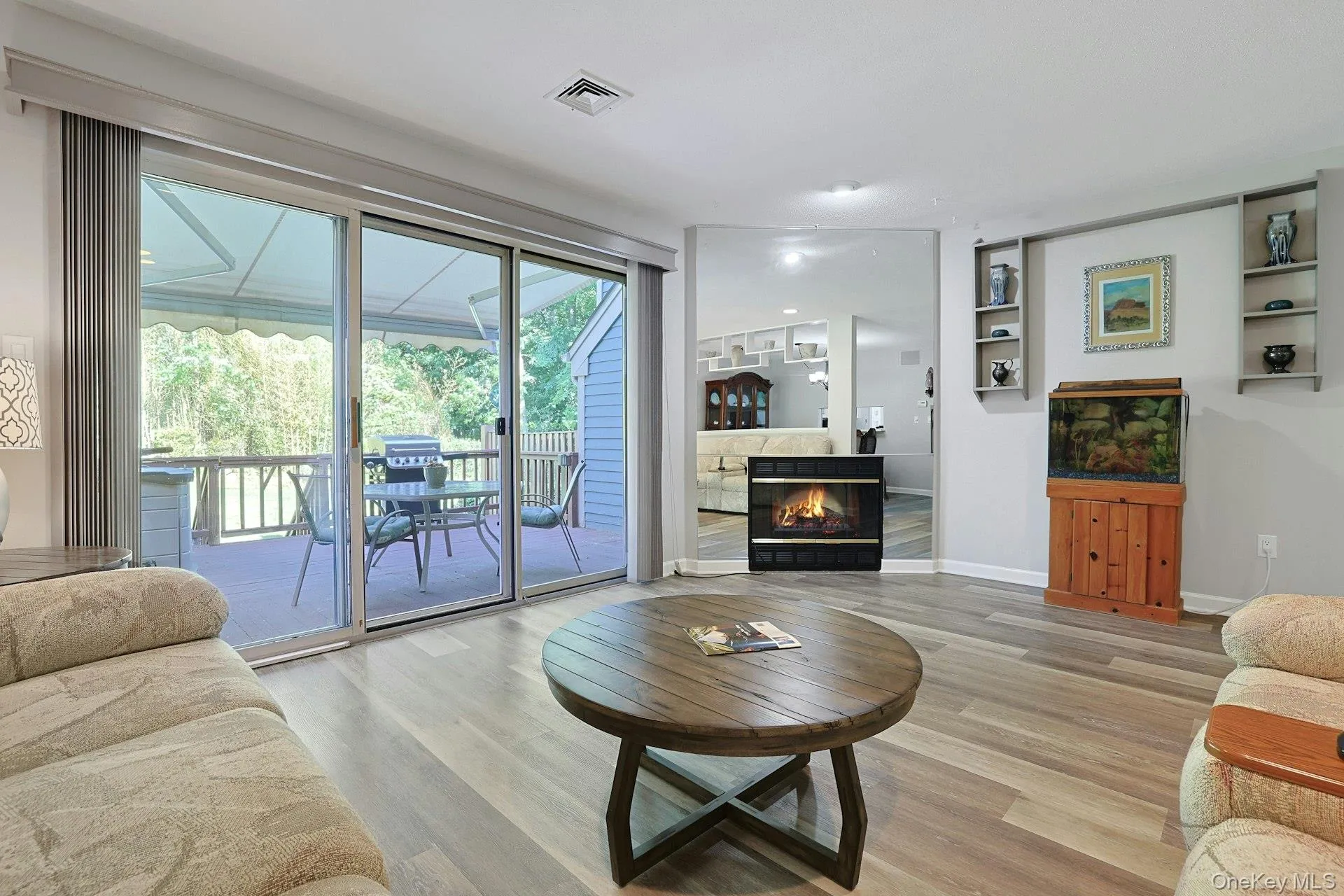 Triple sliding glass windows/doors open out from the livingroom to an oversized 16 x 16 deck. A cozy electric fireplace for warmth and ambiance. Triple sliding glass windows/doors open out from the livingroom to an oversized 16 x 16 deck. A cozy electric fireplace for warmth and ambiance.