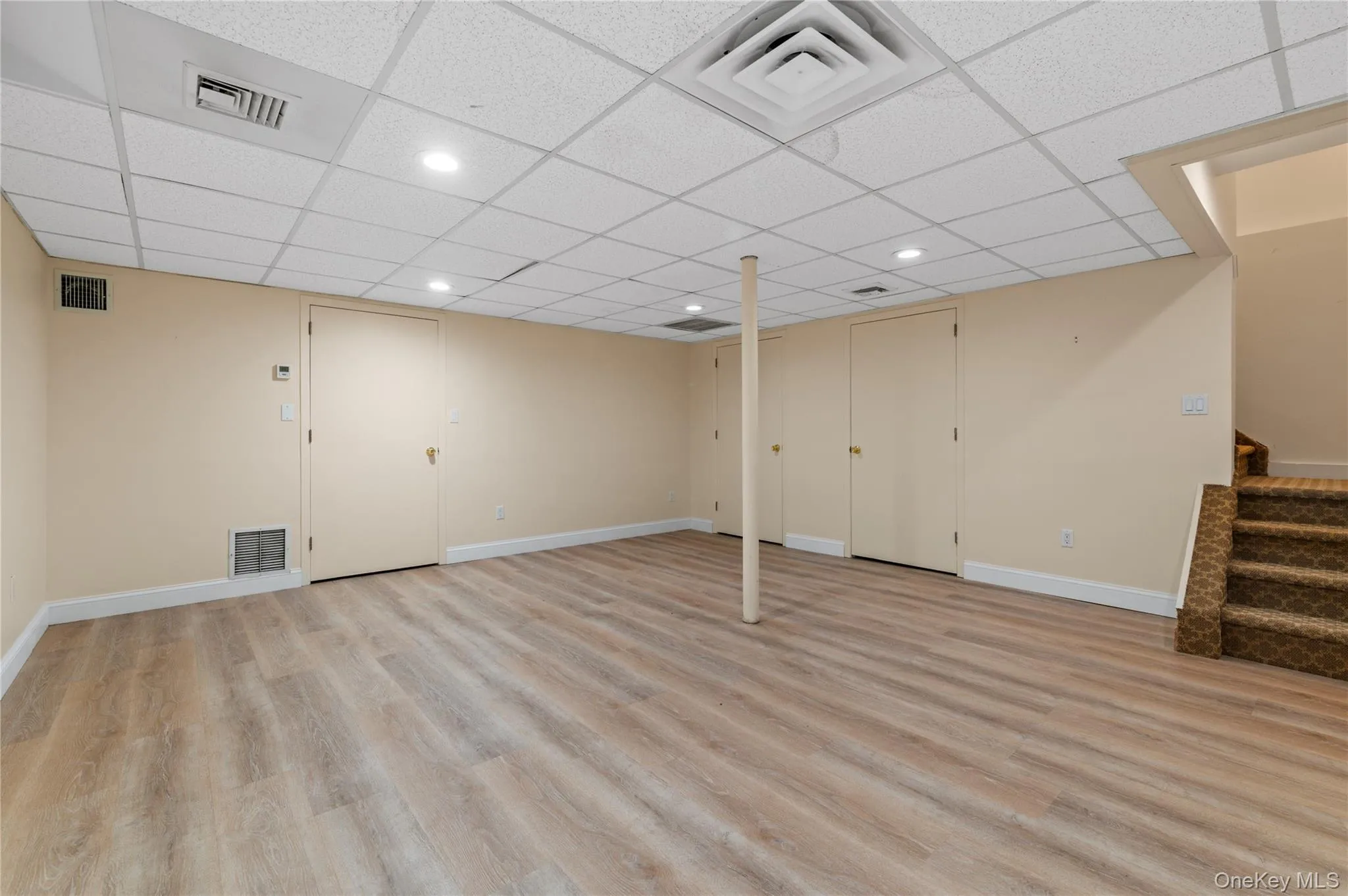 Spacious room featuring light wood-finish flooring, recessed lighting, drop ceiling Spacious room featuring light wood-finish flooring, recessed lighting, drop ceiling