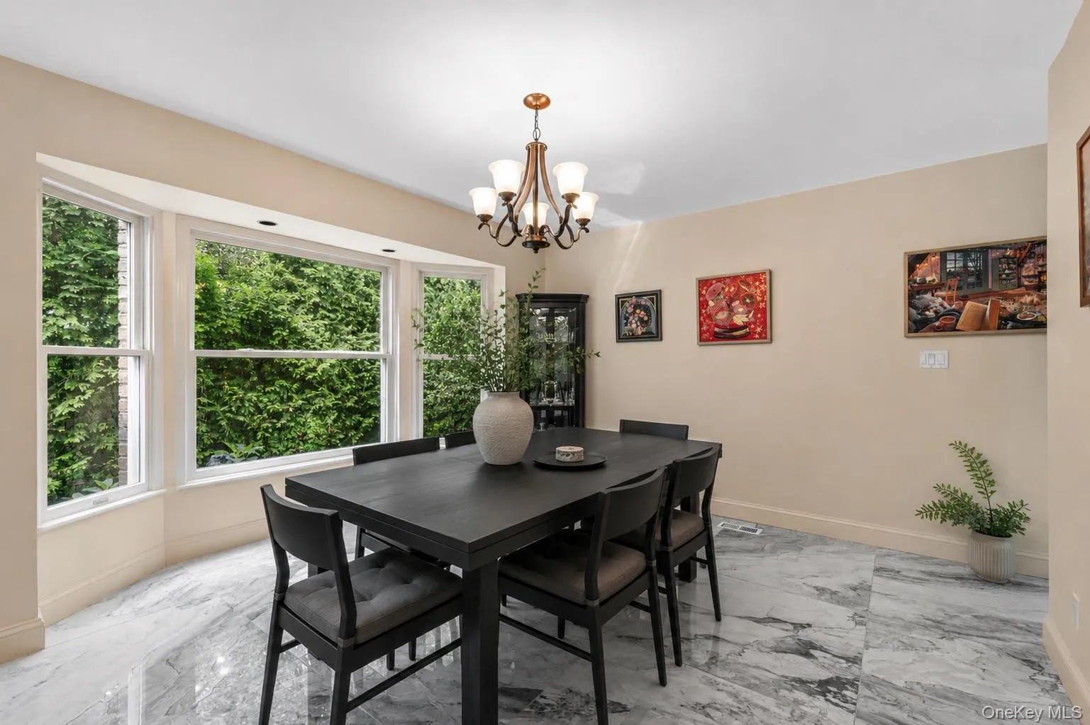 Bay window with white trim, marble-look tile flooring, and a bronze-finish chandelier Bay window with white trim, marble-look tile flooring, and a bronze-finish chandelier