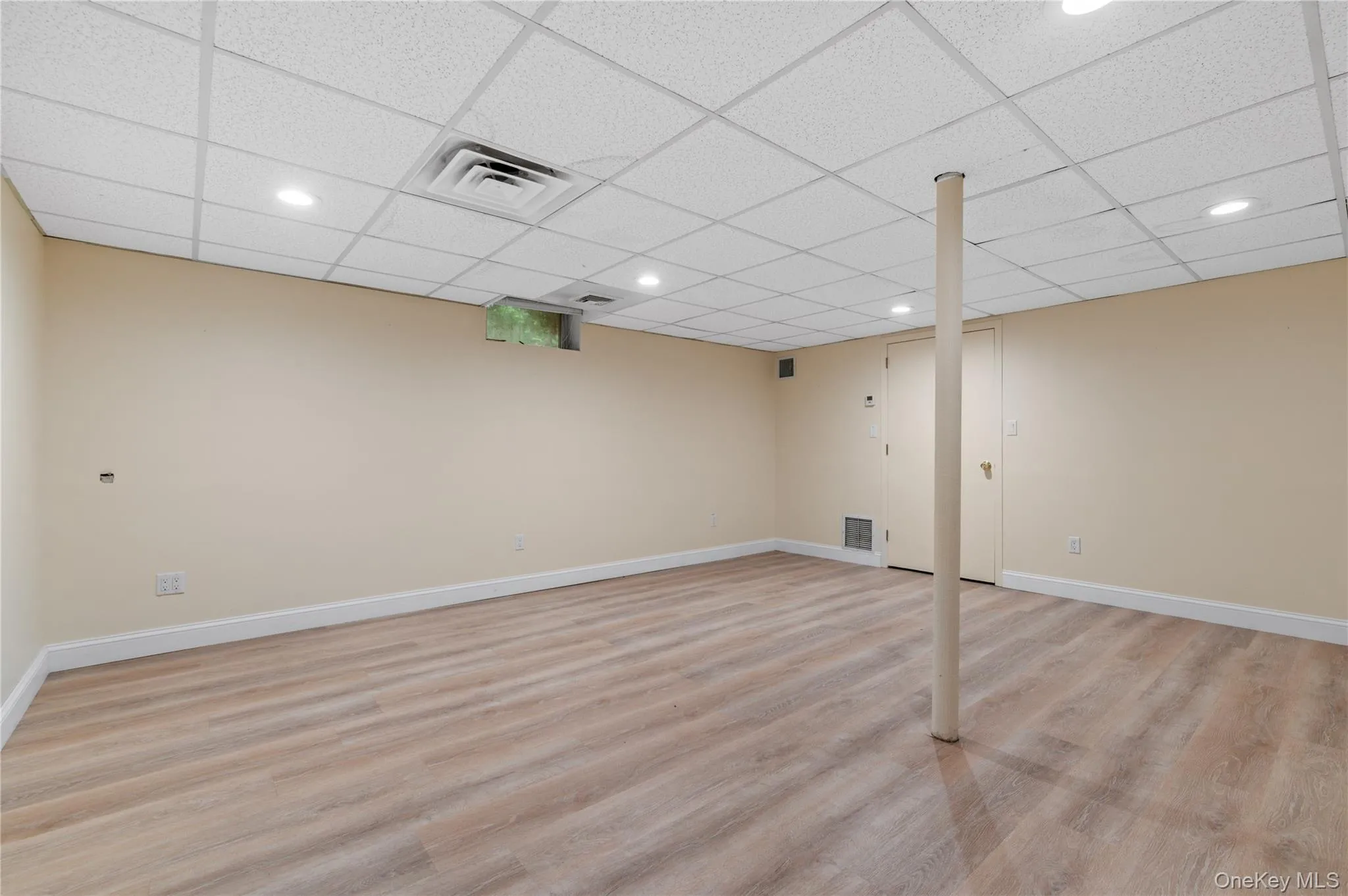 Spacious room featuring light wood-finish flooring, recessed lighting, drop ceiling Spacious room featuring light wood-finish flooring, recessed lighting, drop ceiling