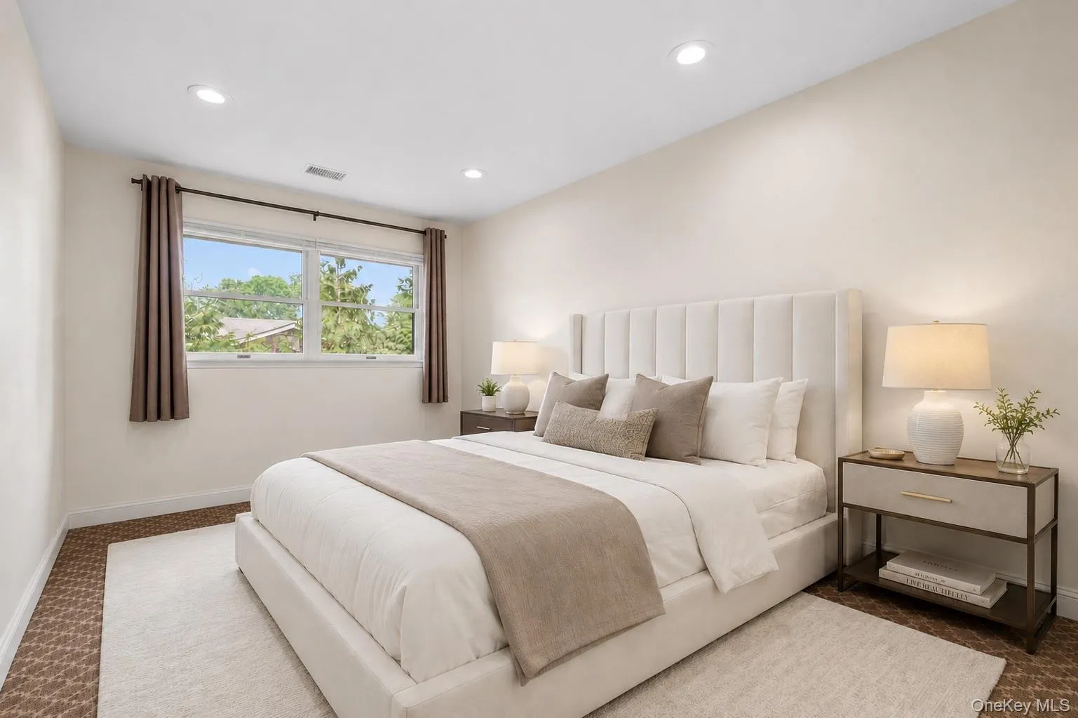 Bedroom featuring recessed lighting, a large window, neutral wall tones, and patterned carpet flooring Bedroom featuring recessed lighting, a large window, neutral wall tones, and patterned carpet flooring