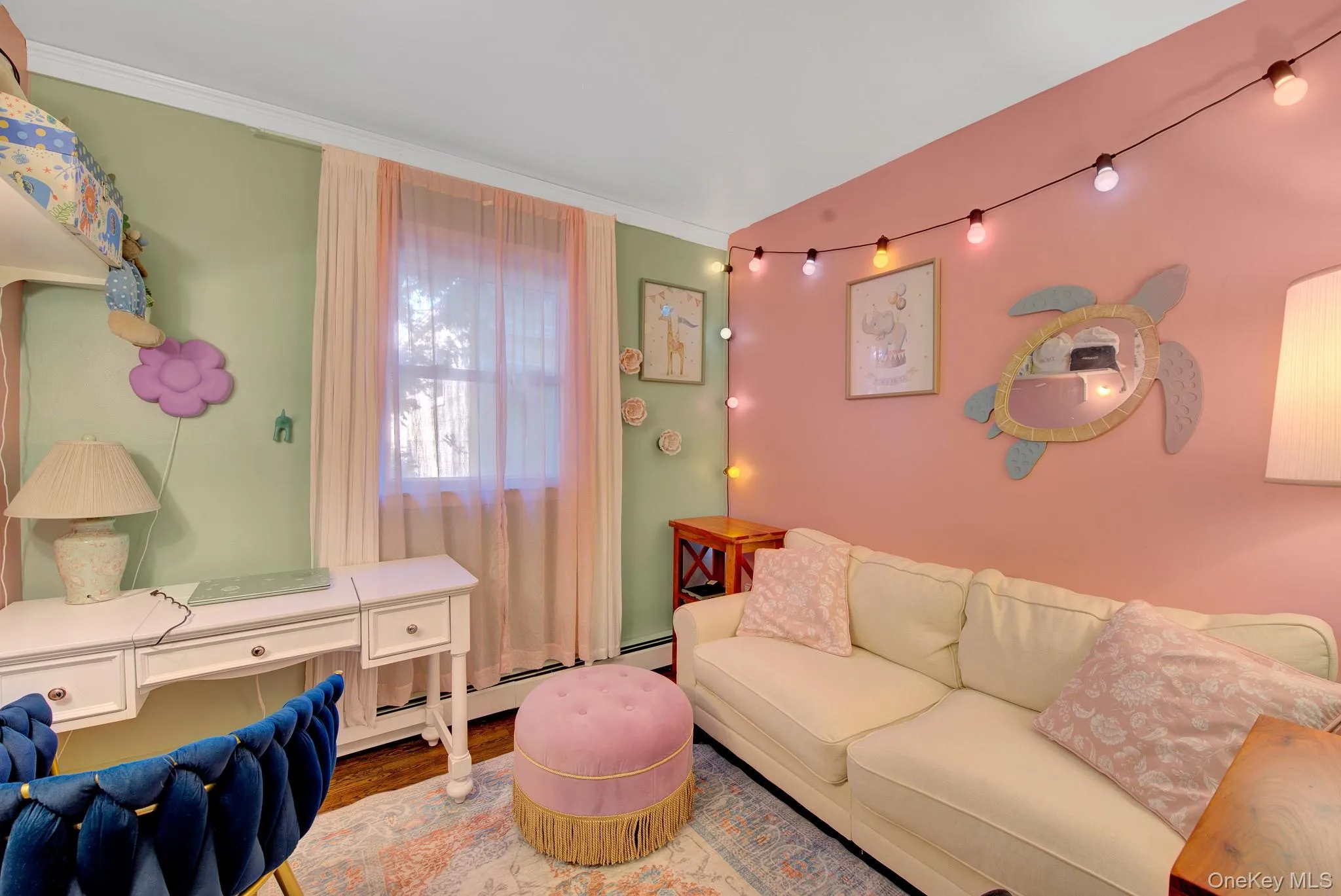 Light-filled room featuring a window with sheer curtains, a white desk, and multi-toned walls Light-filled room featuring a window with sheer curtains, a white desk, and multi-toned walls