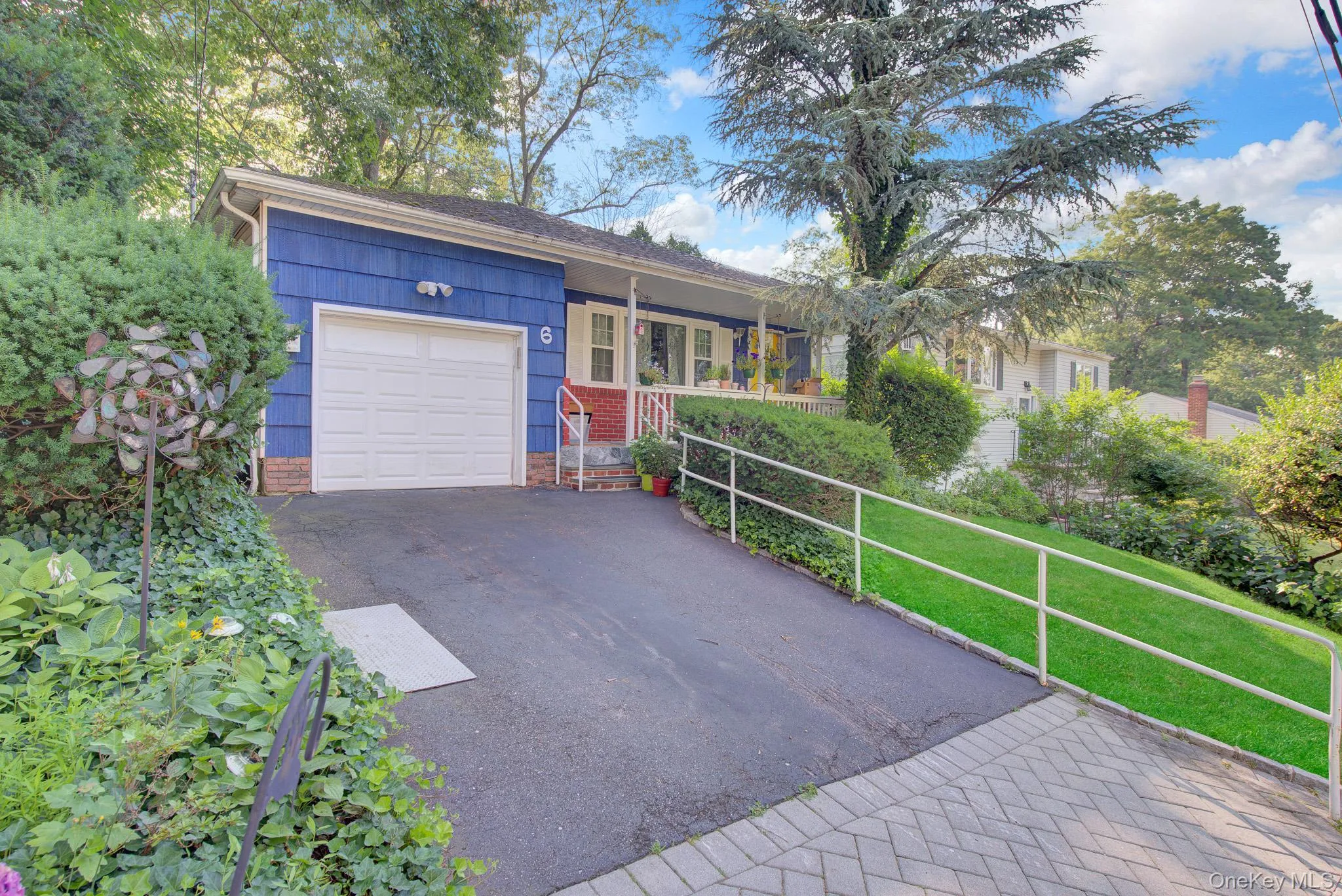 Blue siding exterior with a white garage door Blue siding exterior with a white garage door