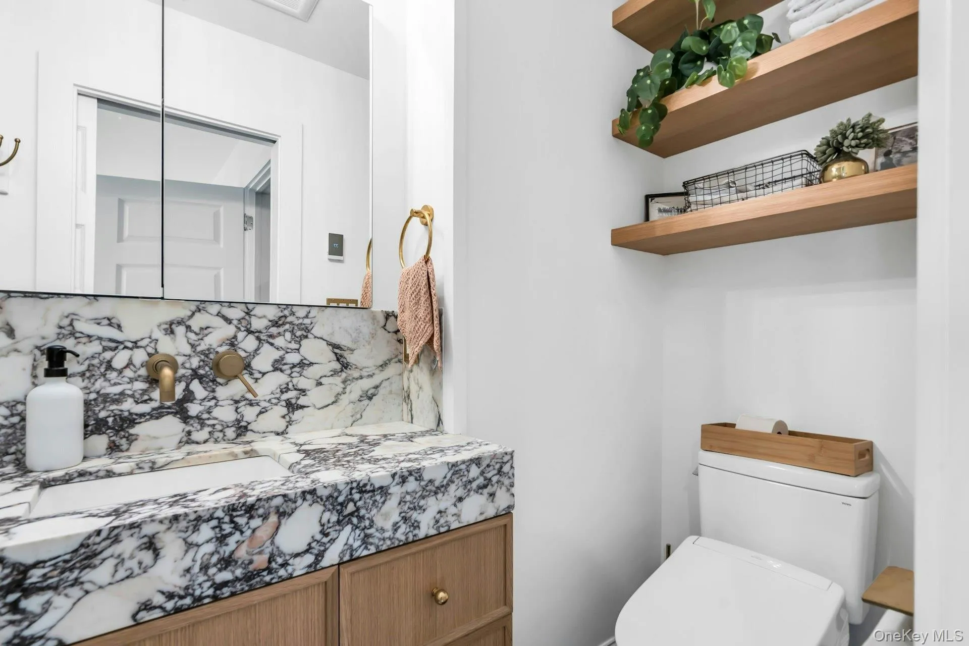 Newly renovated luxury marble bathroom with custom sink, shelving and Toto toilet Newly renovated luxury marble bathroom with custom sink, shelving and Toto toilet