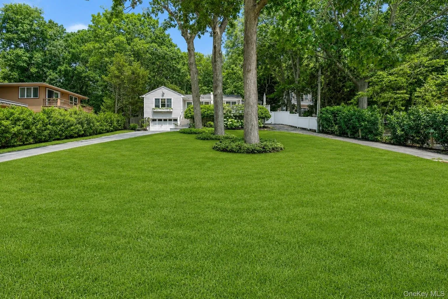 Circular driveway with plenty of parking, grassy front yard and water views Circular driveway with plenty of parking, grassy front yard and water views
