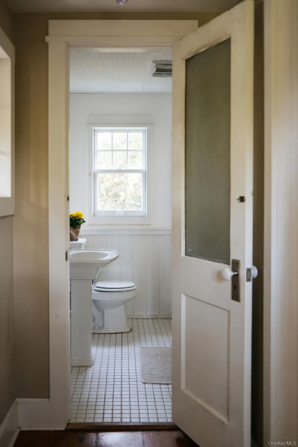Bathroom with wainscoting and a decorative wall Bathroom with wainscoting and a decorative wall