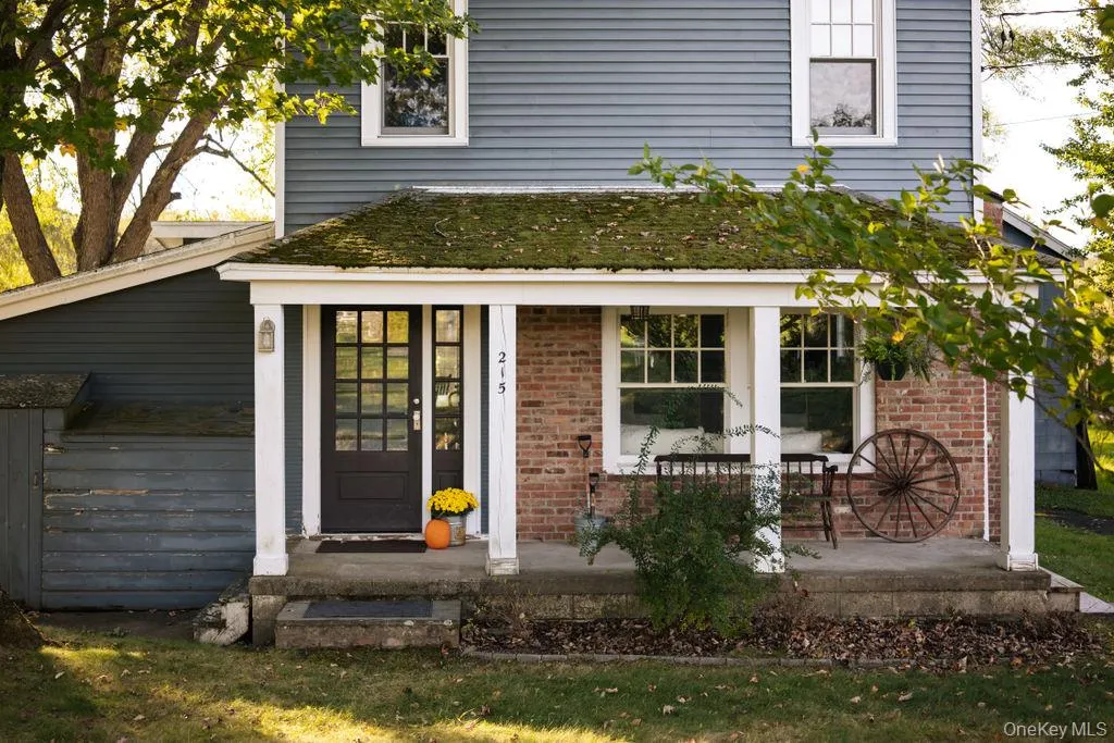 View of exterior entry with brick siding and a porch View of exterior entry with brick siding and a porch