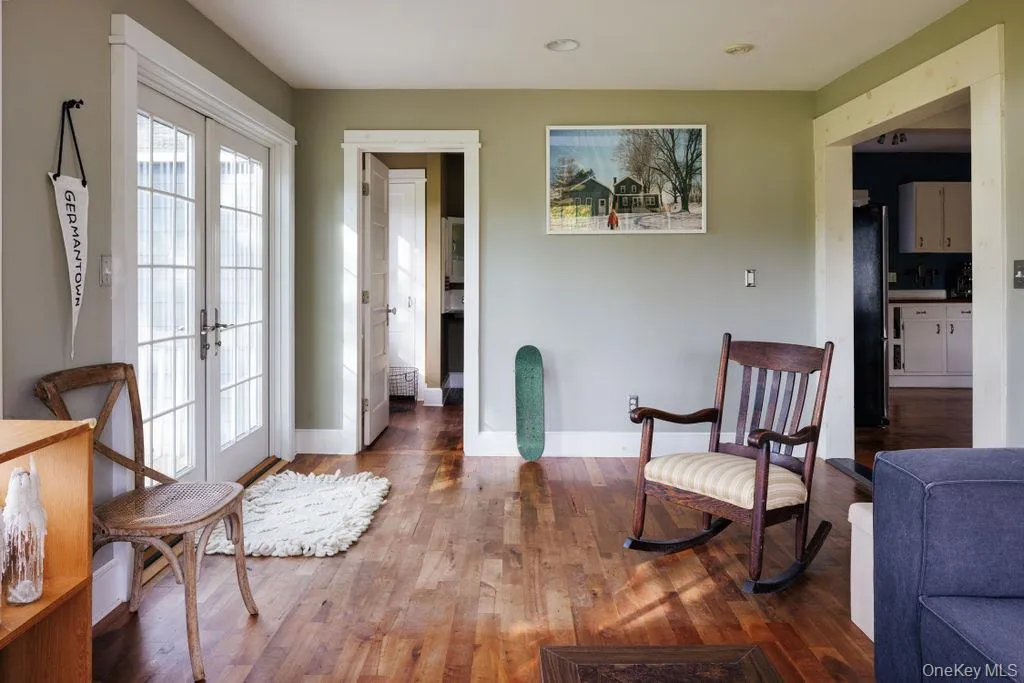 Sun room featuring hardwood / wood-style floors and french doors Sun room featuring hardwood / wood-style floors and french doors