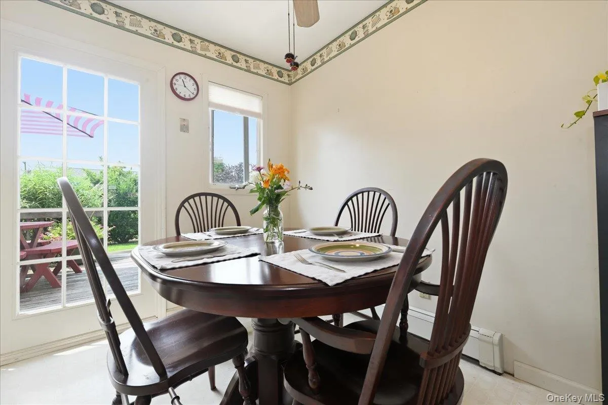 Dining area featuring a glass-paned exterior door providing direct access to an outdoor deck Dining area featuring a glass-paned exterior door providing direct access to an outdoor deck