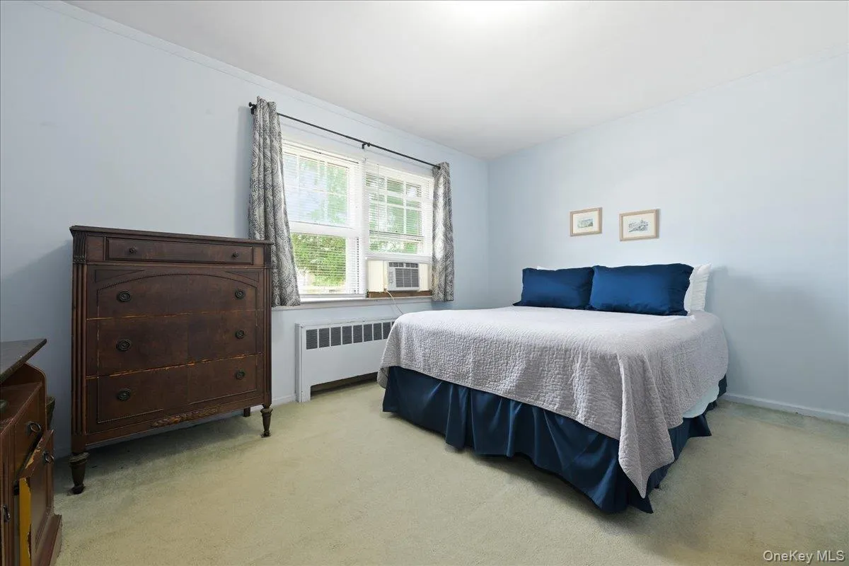 Primary Bedroom featuring light blue wall paint and light-colored carpeting Primary Bedroom featuring light blue wall paint and light-colored carpeting