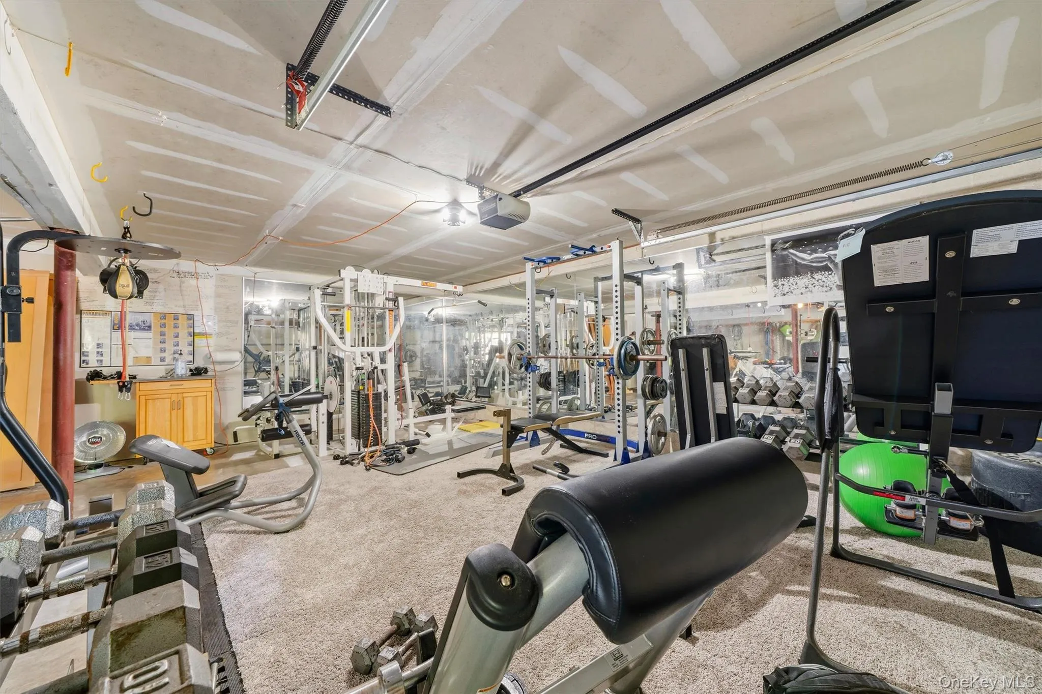 2 car garage currently used as an expansive exercise and weight room. Equipment is available for sale if desired. 2 car garage currently used as an expansive exercise and weight room. Equipment is available for sale if desired.
