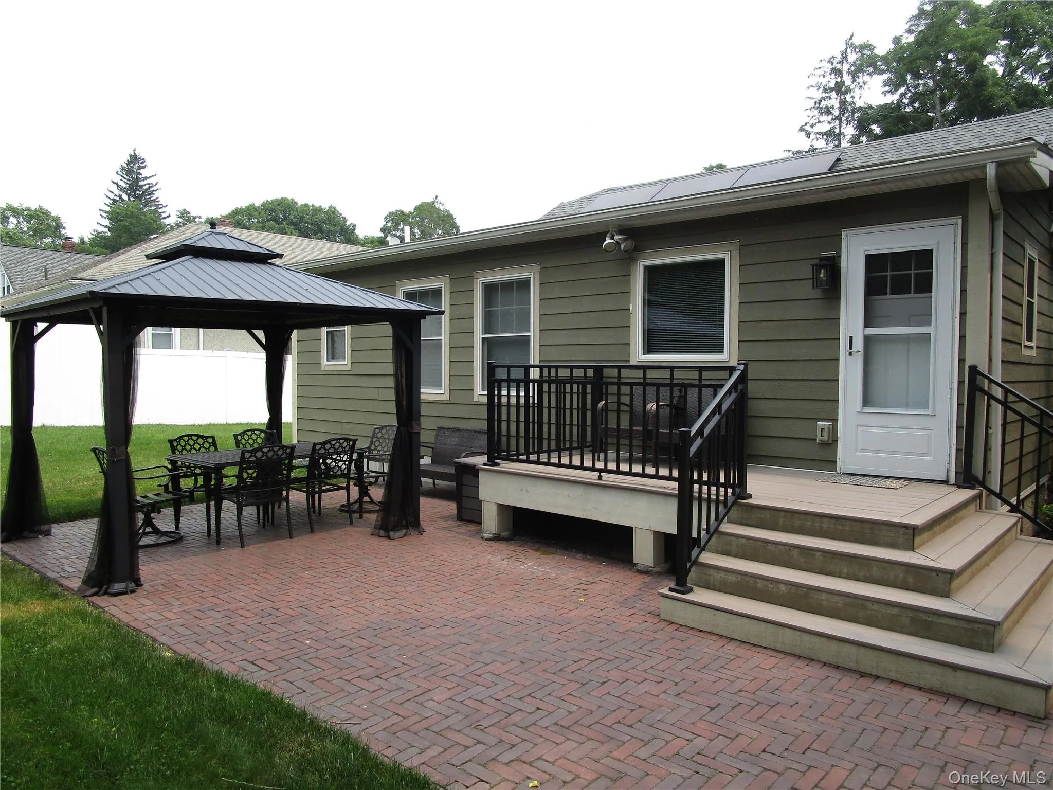 paved patio, composite decking, gazebo in rear of house. paved patio, composite decking, gazebo in rear of house.