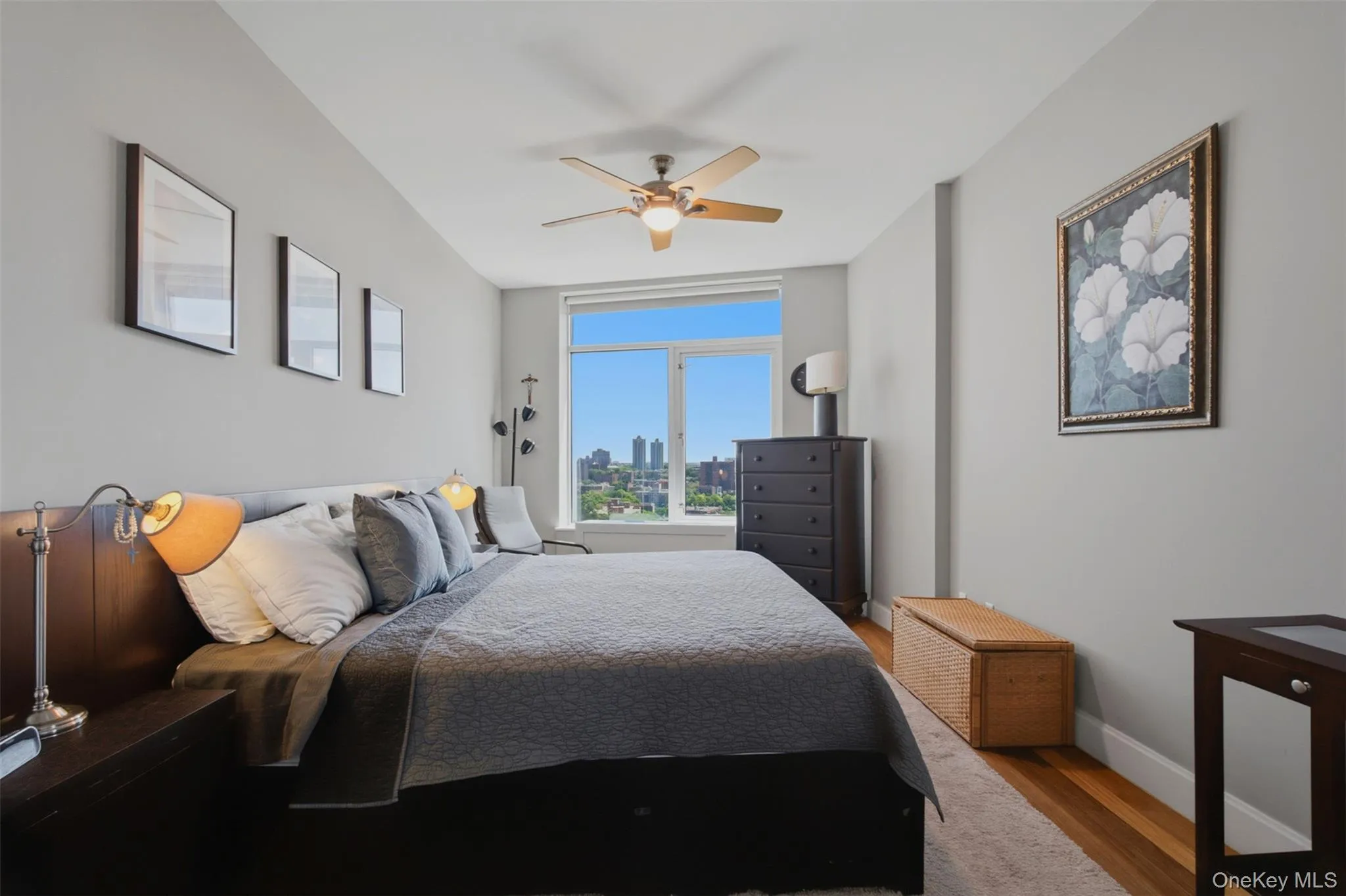 Bedroom 2 featuring a large window with city and tree-lined Bedroom 2 featuring a large window with city and tree-lined