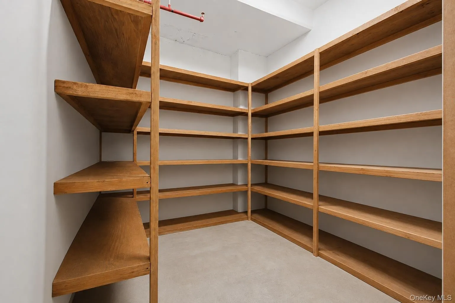 Custom shelving system with wood-finish construction providing extensive storage Custom shelving system with wood-finish construction providing extensive storage
