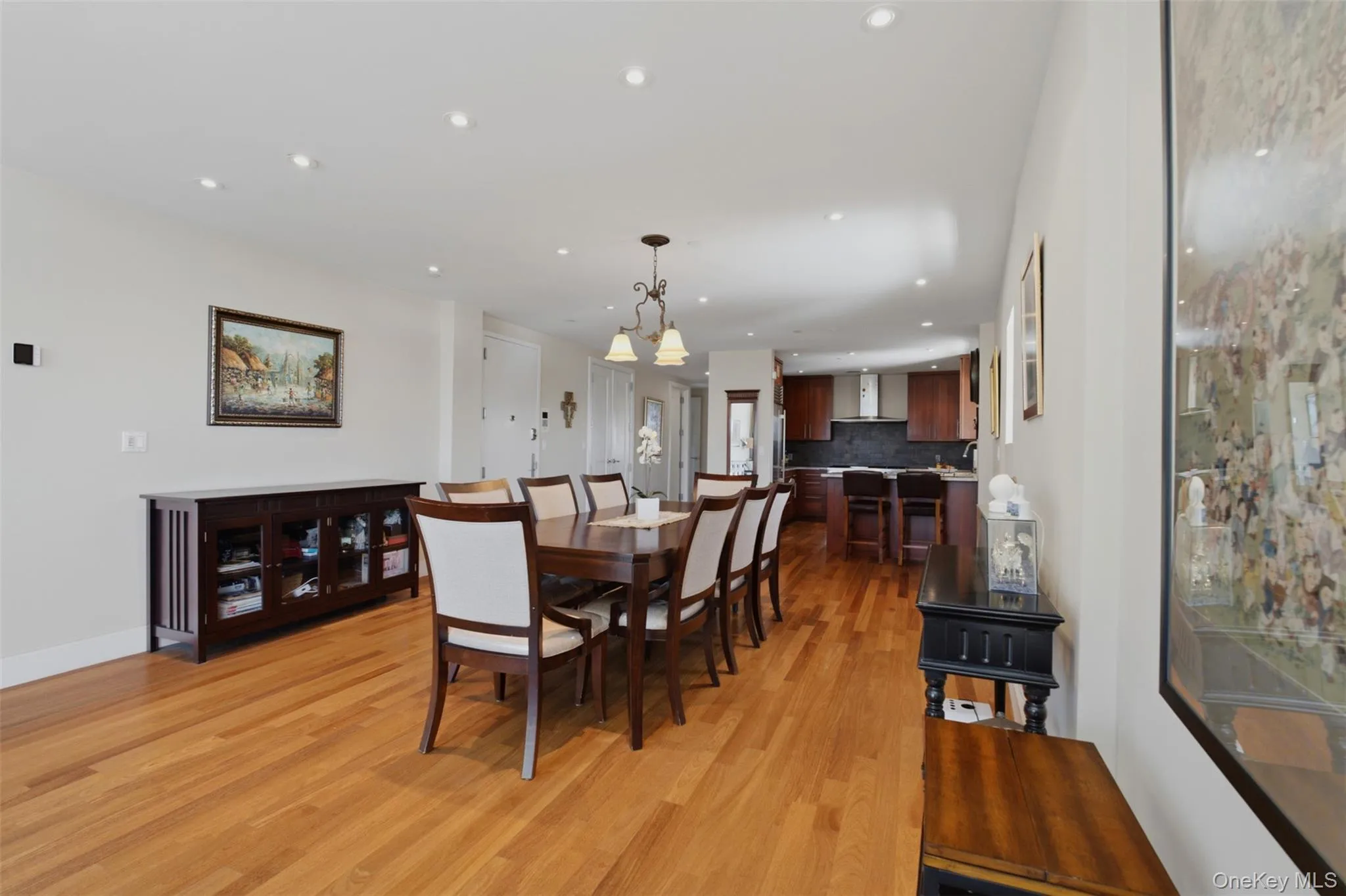 Open-concept dining area with wood-finish flooring, recessed lighting, and a chandelier Open-concept dining area with wood-finish flooring, recessed lighting, and a chandelier