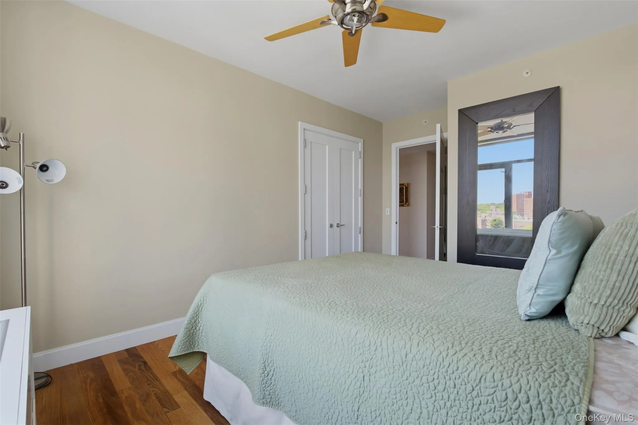Bedroom 3. Light-filled room featuring wood-finish flooring, a ceiling fan, and white baseboards Bedroom 3. Light-filled room featuring wood-finish flooring, a ceiling fan, and white baseboards