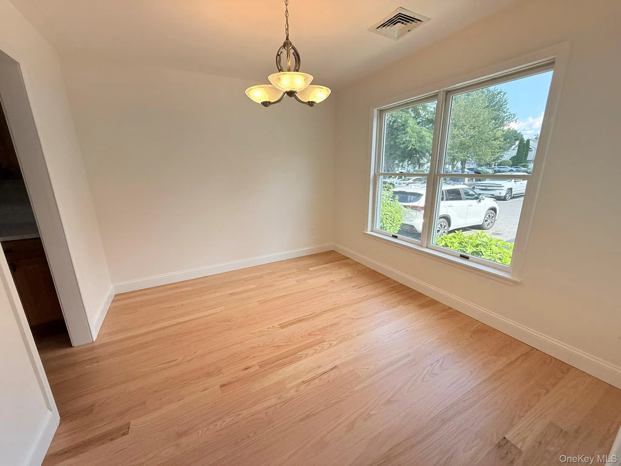 Bright dining room with hardwood floors, large windows, and plenty of natural light, ideal for everyday meals and entertaining. Bright dining room with hardwood floors, large windows, and plenty of natural light, ideal for everyday meals and entertaining.