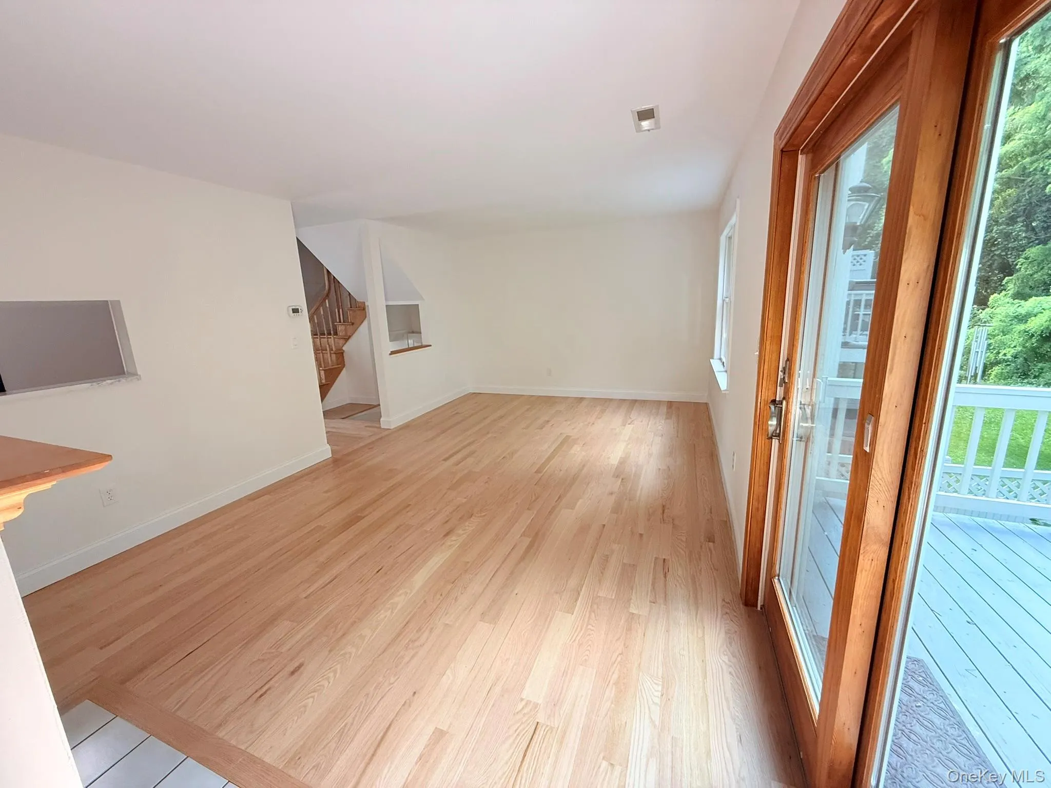 Another view of the spacious living room, featuring beautiful natural light and sliding glass doors that opens to the deck. Another view of the spacious living room, featuring beautiful natural light and sliding glass doors that opens to the deck.
