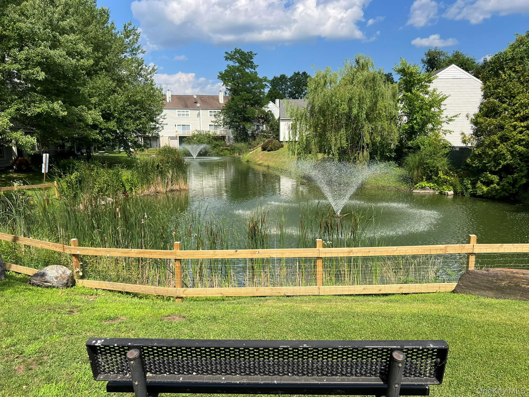 A picturesque pond with a charming bench creates a peaceful place to sit back, unwind, and enjoy the beauty of the surrounding landscape. A picturesque pond with a charming bench creates a peaceful place to sit back, unwind, and enjoy the beauty of the surrounding landscape.