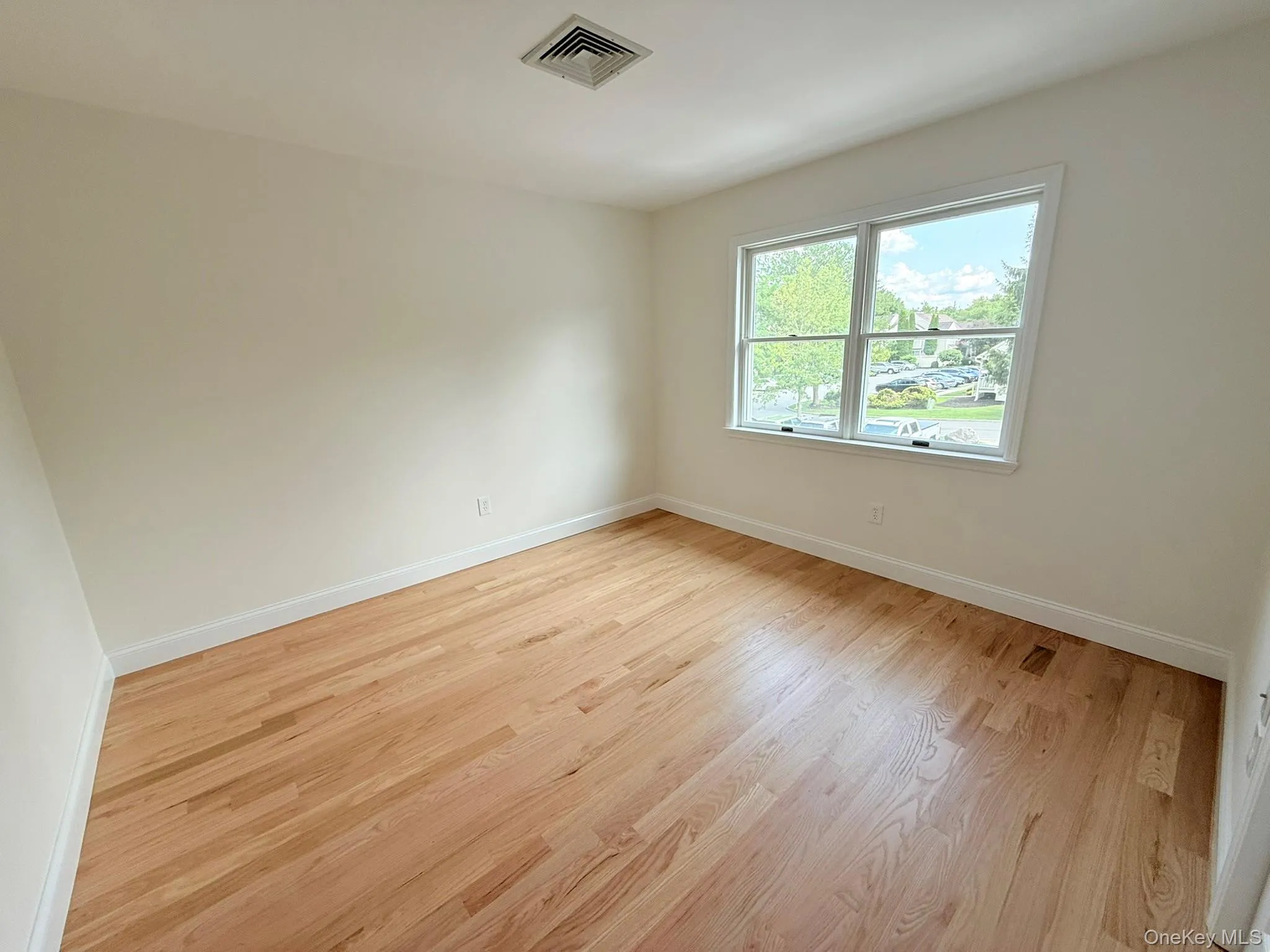A bright second bedroom, ideal for guests, a home office, or additional living space. A bright second bedroom, ideal for guests, a home office, or additional living space.