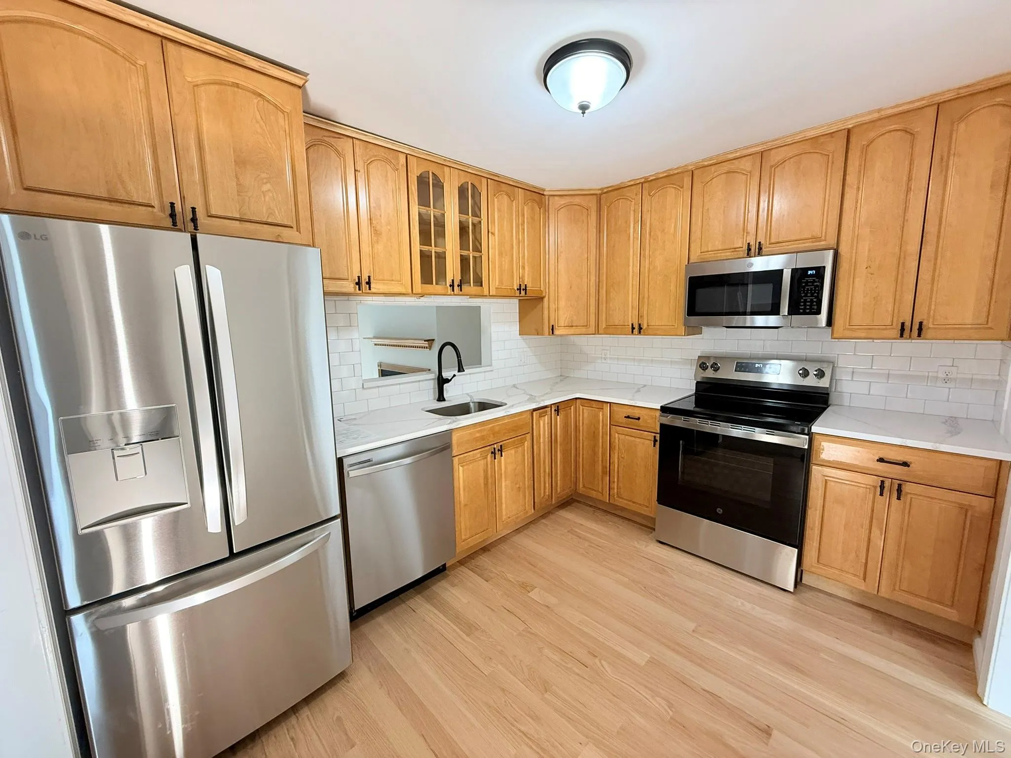 The kitchen with a pass-through opening to the living room, creating an easy connection between spaces. The kitchen with a pass-through opening to the living room, creating an easy connection between spaces.