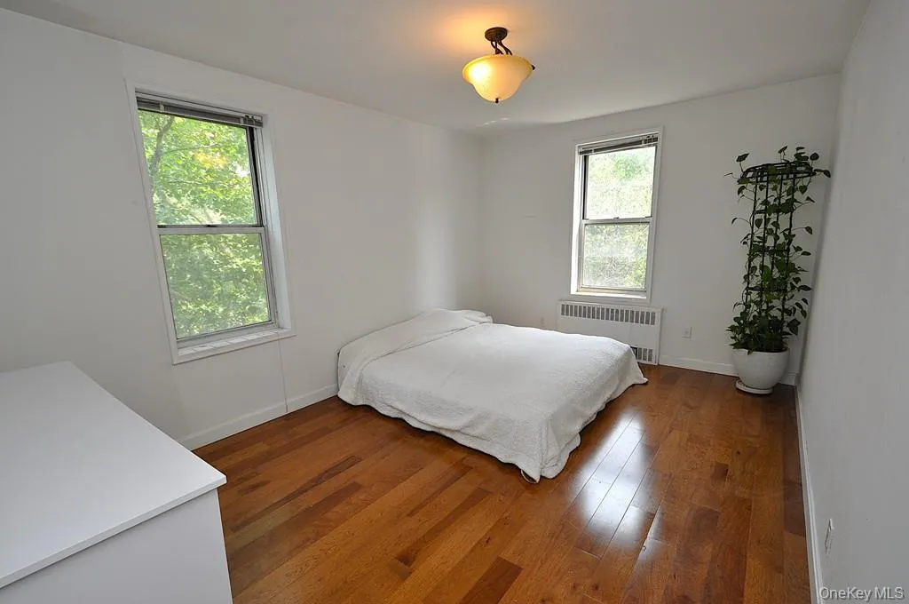Large corner second bedroom has new hardwood floors . Large corner second bedroom has new hardwood floors .