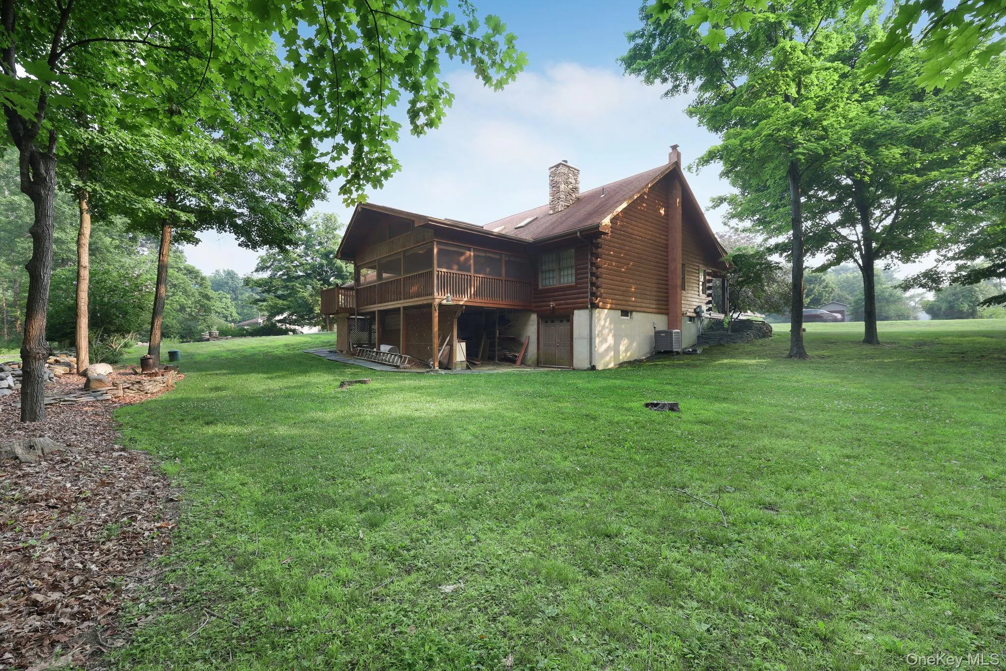 Back of the home shown here with the enclosed scren porch and basement entry door. Back of the home shown here with the enclosed scren porch and basement entry door.