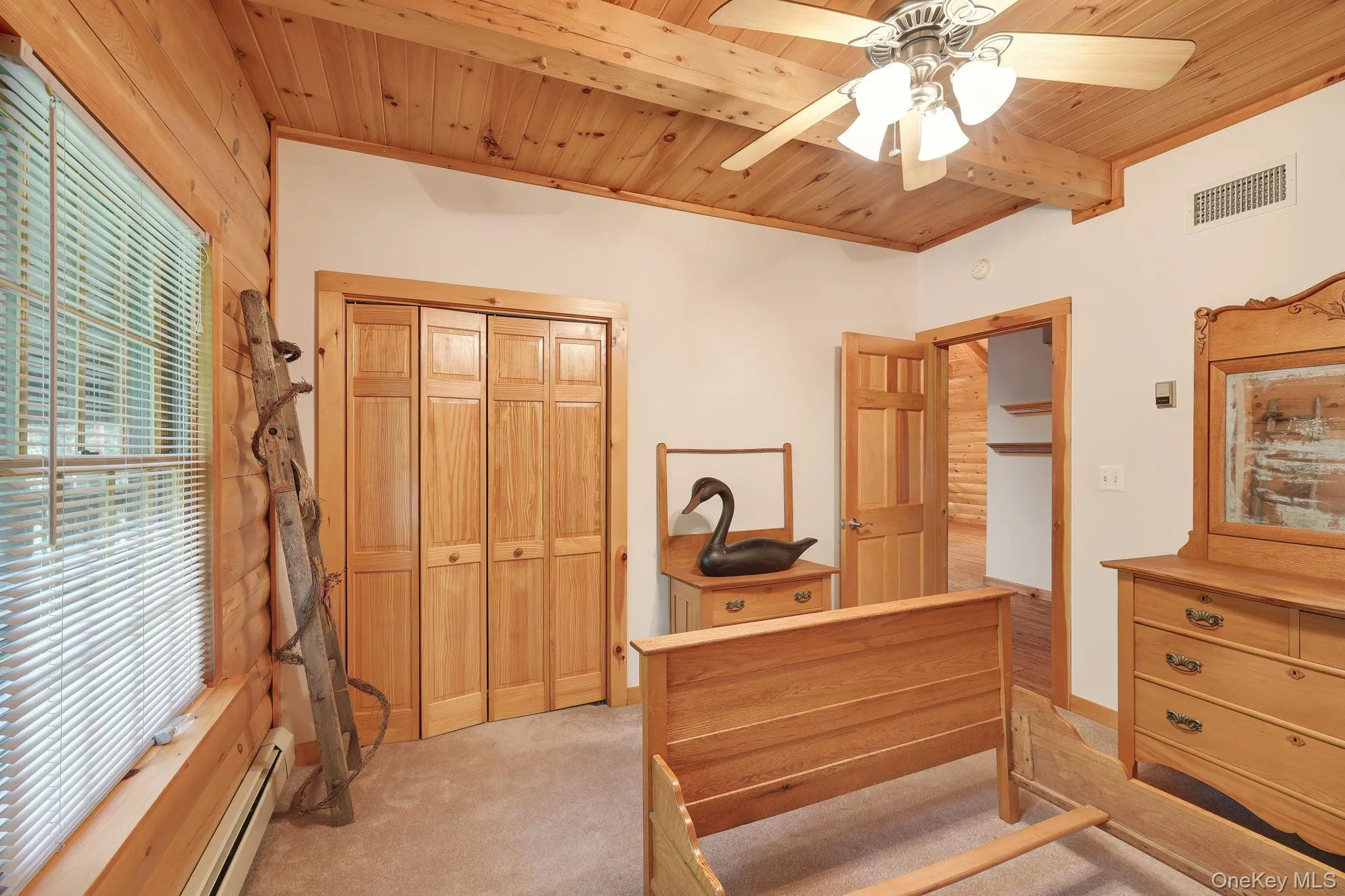 This bedroom overlooks the yard and has an overhead ceiling light fan combination. This bedroom overlooks the yard and has an overhead ceiling light fan combination.