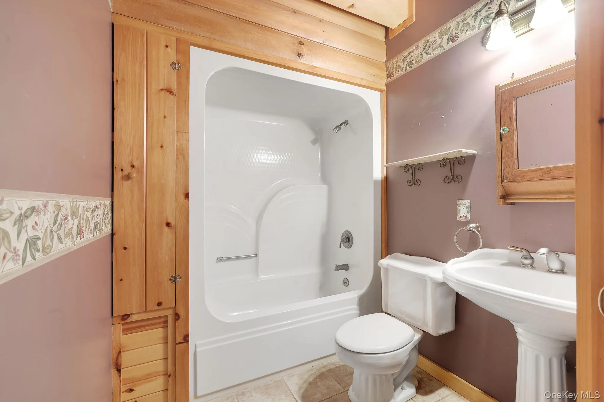 This bathroom has a shower/tub combination and a pocket door for privacy. This bathroom has a shower/tub combination and a pocket door for privacy.