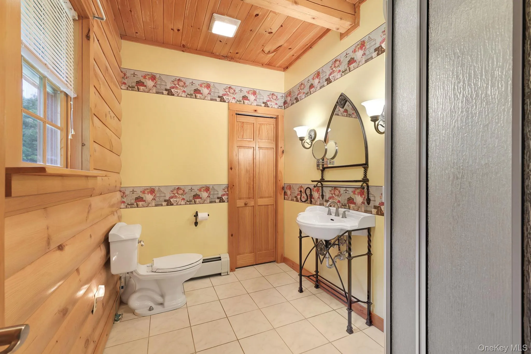 Bathroom featuring a dressing area, shower, closet and ample lighting on either side of the sink. Bathroom featuring a dressing area, shower, closet and ample lighting on either side of the sink.