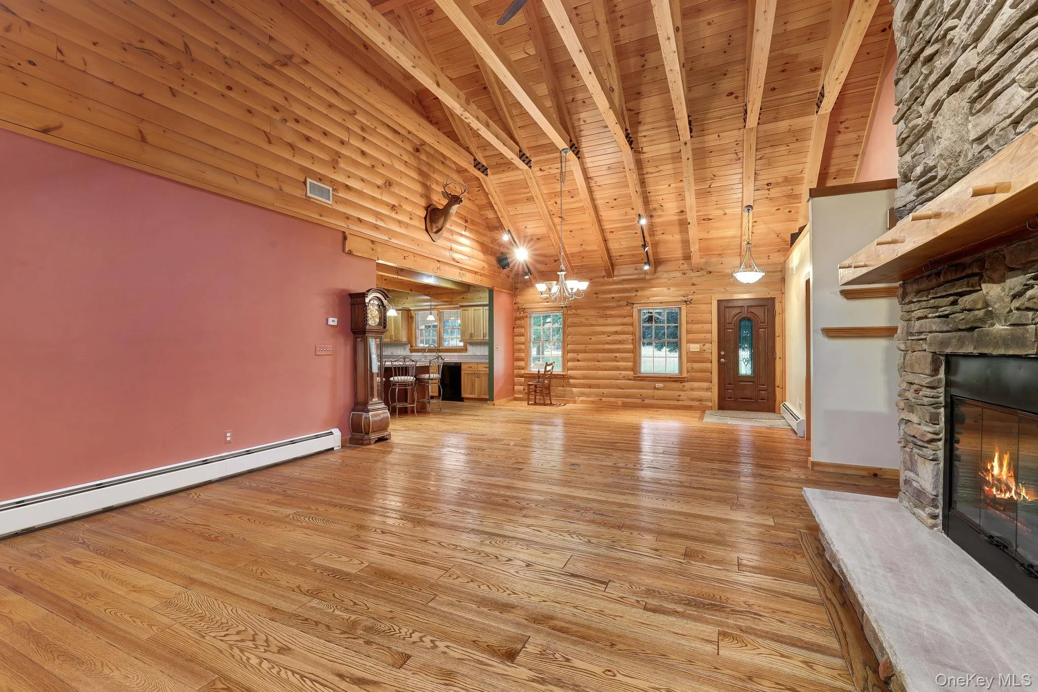 Expansive living area featuring a stone fireplace with a substantial hearth. Expansive living area featuring a stone fireplace with a substantial hearth.