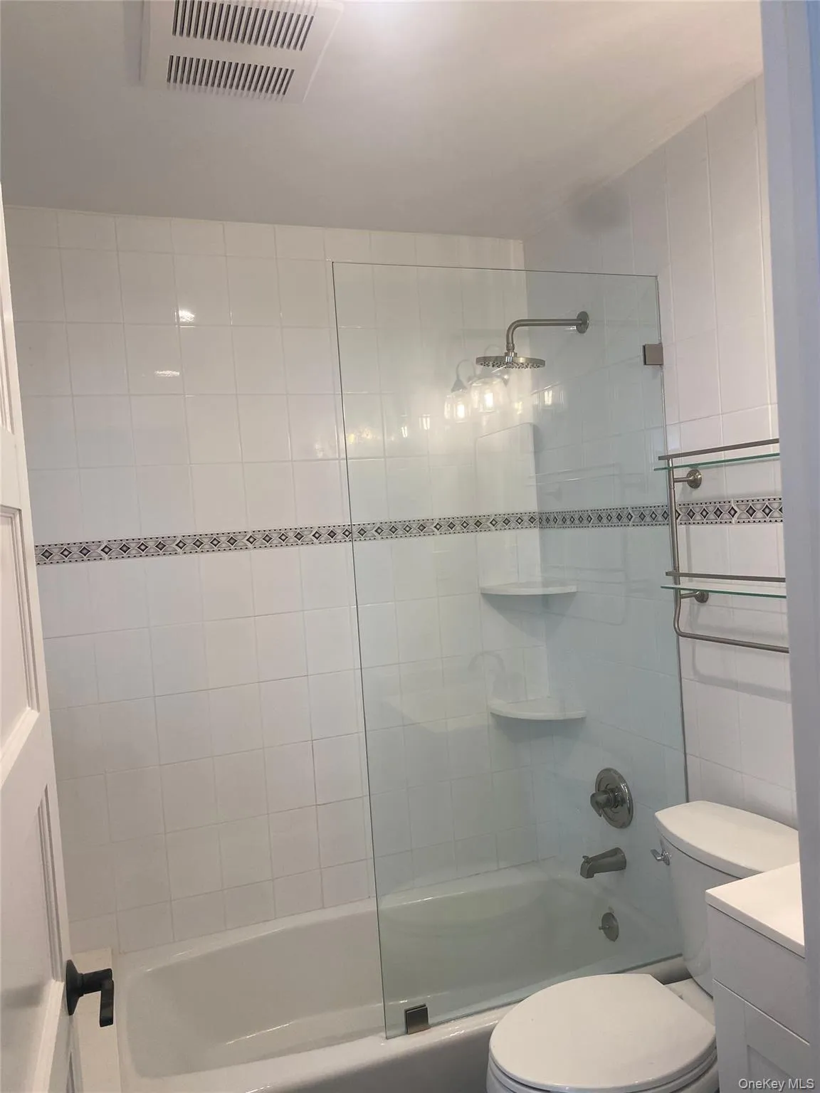 Bathroom featuring combined bath / shower with glass door and vanity Bathroom featuring combined bath / shower with glass door and vanity