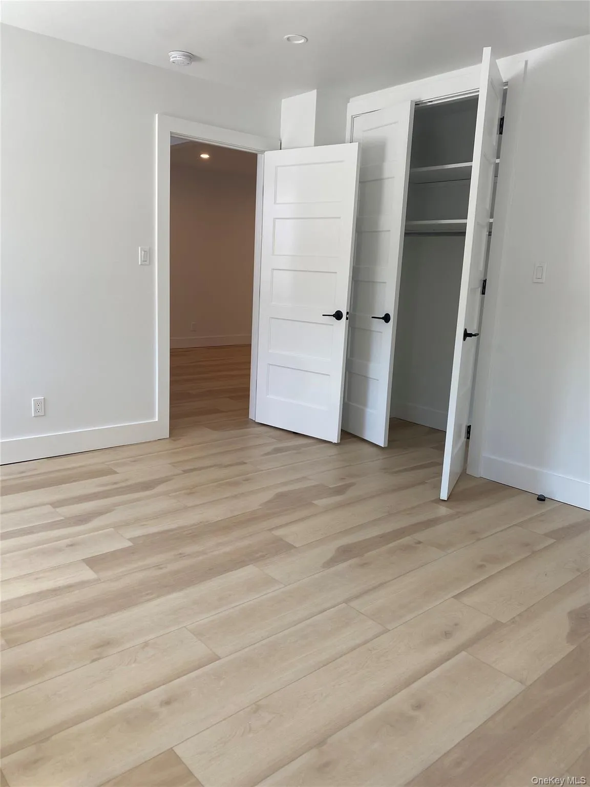 Unfurnished bedroom featuring light wood-style floors, a closet, and recessed lighting Unfurnished bedroom featuring light wood-style floors, a closet, and recessed lighting