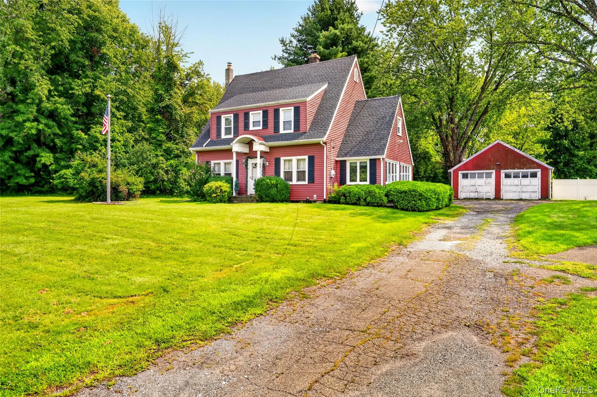 Red siding exterior with white trim, two car detached garage Red siding exterior with white trim, two car detached garage