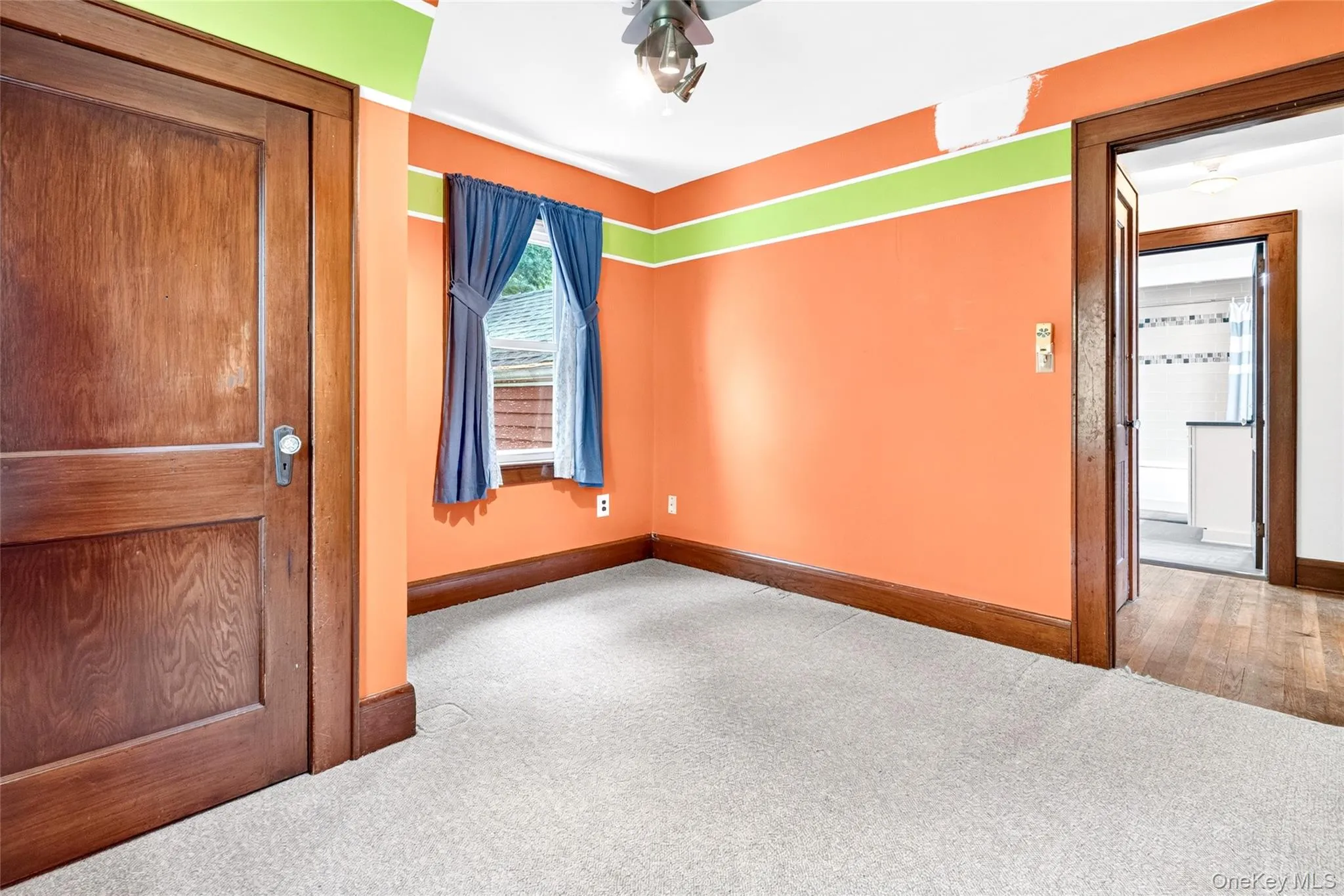 Carpeted flooring, wood-finish door, wood-finish trim, window, ceiling fan Carpeted flooring, wood-finish door, wood-finish trim, window, ceiling fan