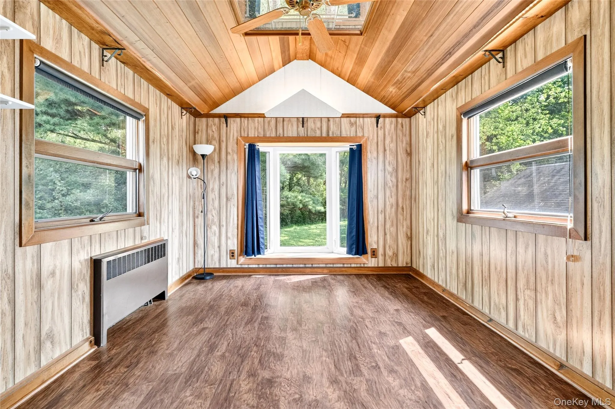 Wood-finish flooring with wood-paneled walls and a vaulted wood-paneled ceiling Wood-finish flooring with wood-paneled walls and a vaulted wood-paneled ceiling