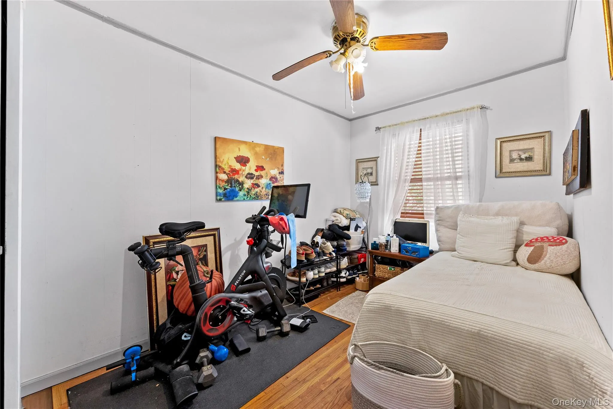Bedroom 2 - Featuring wood-finish flooring, white walls, and a ceiling fan with integrated lighting Bedroom 2 - Featuring wood-finish flooring, white walls, and a ceiling fan with integrated lighting