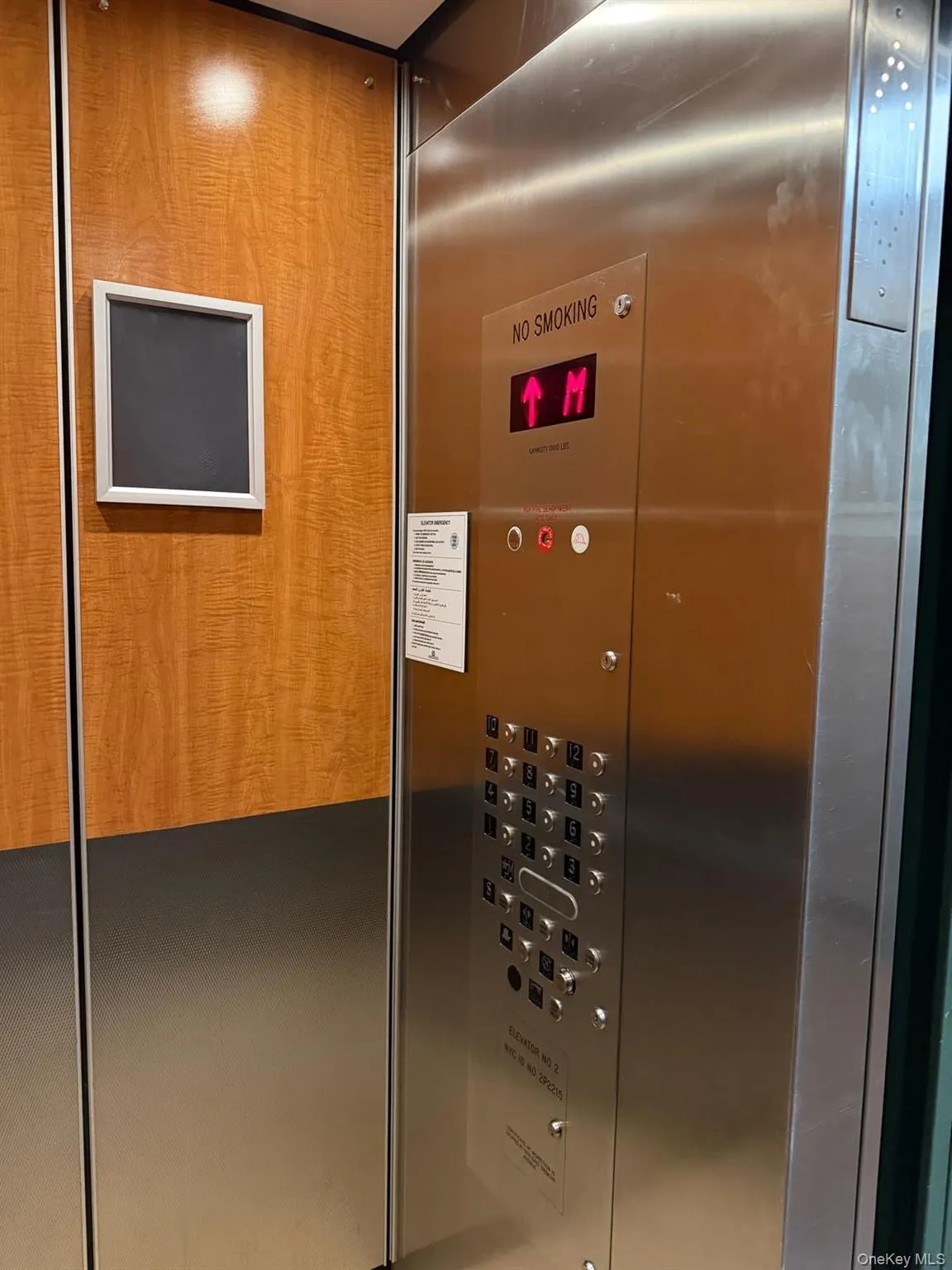 Elevator interior featuring stainless steel panels and wood-finish wall accents Elevator interior featuring stainless steel panels and wood-finish wall accents