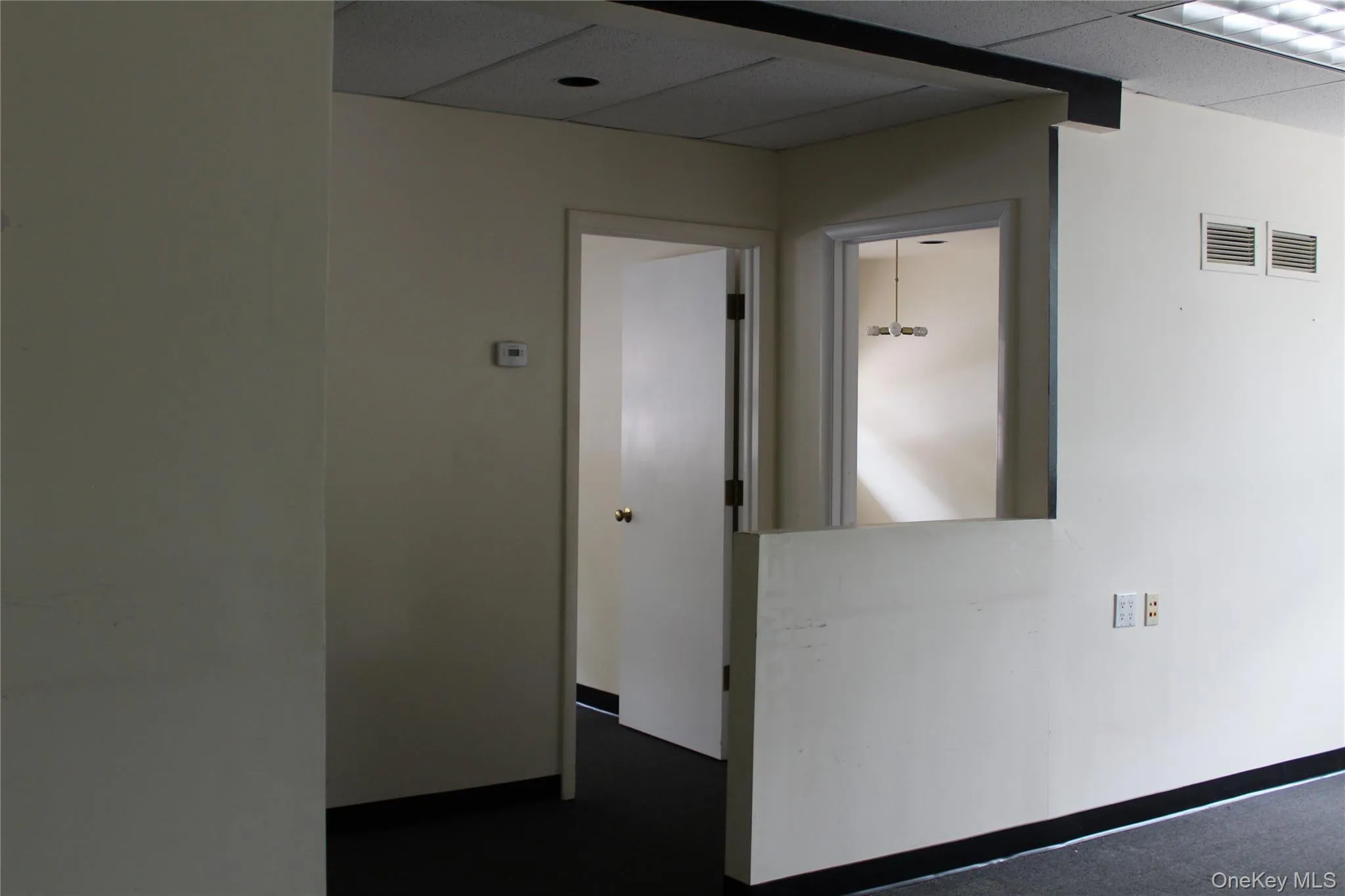 view of door to conference room and an office view of door to conference room and an office
