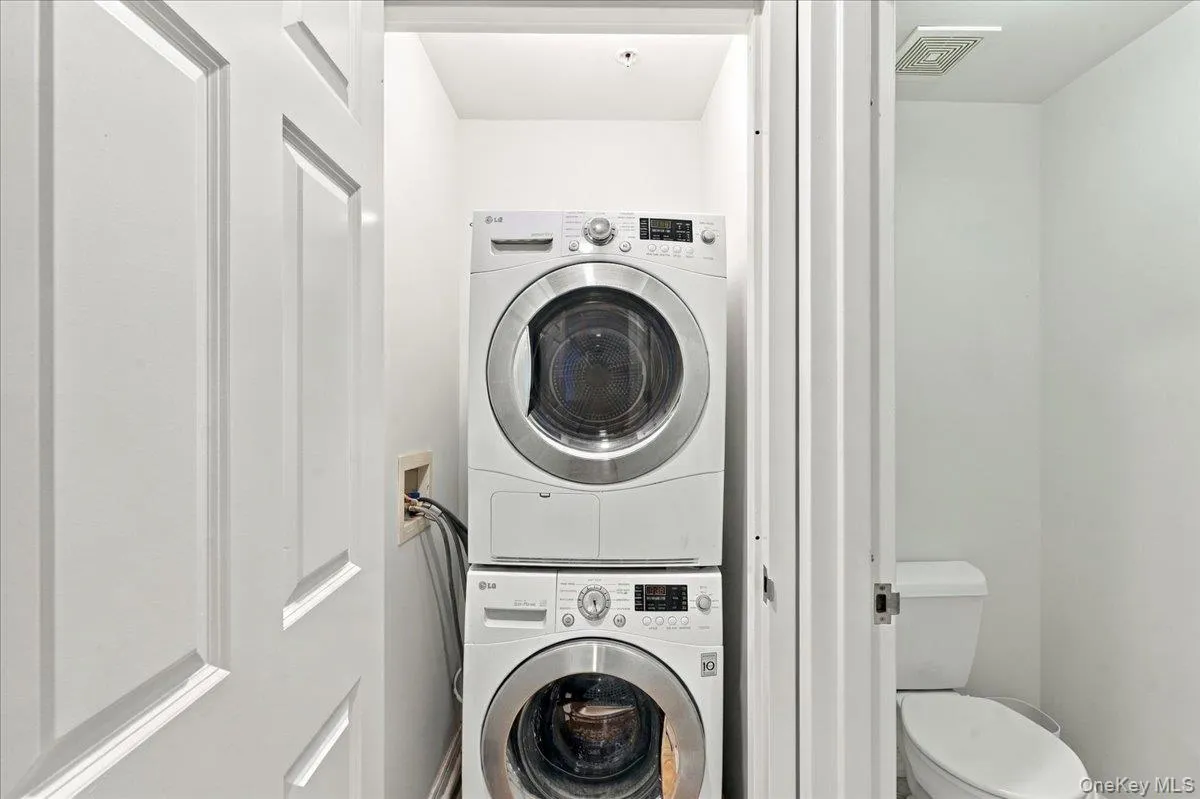 Stackable laundry appliances within a dedicated utility space Stackable laundry appliances within a dedicated utility space