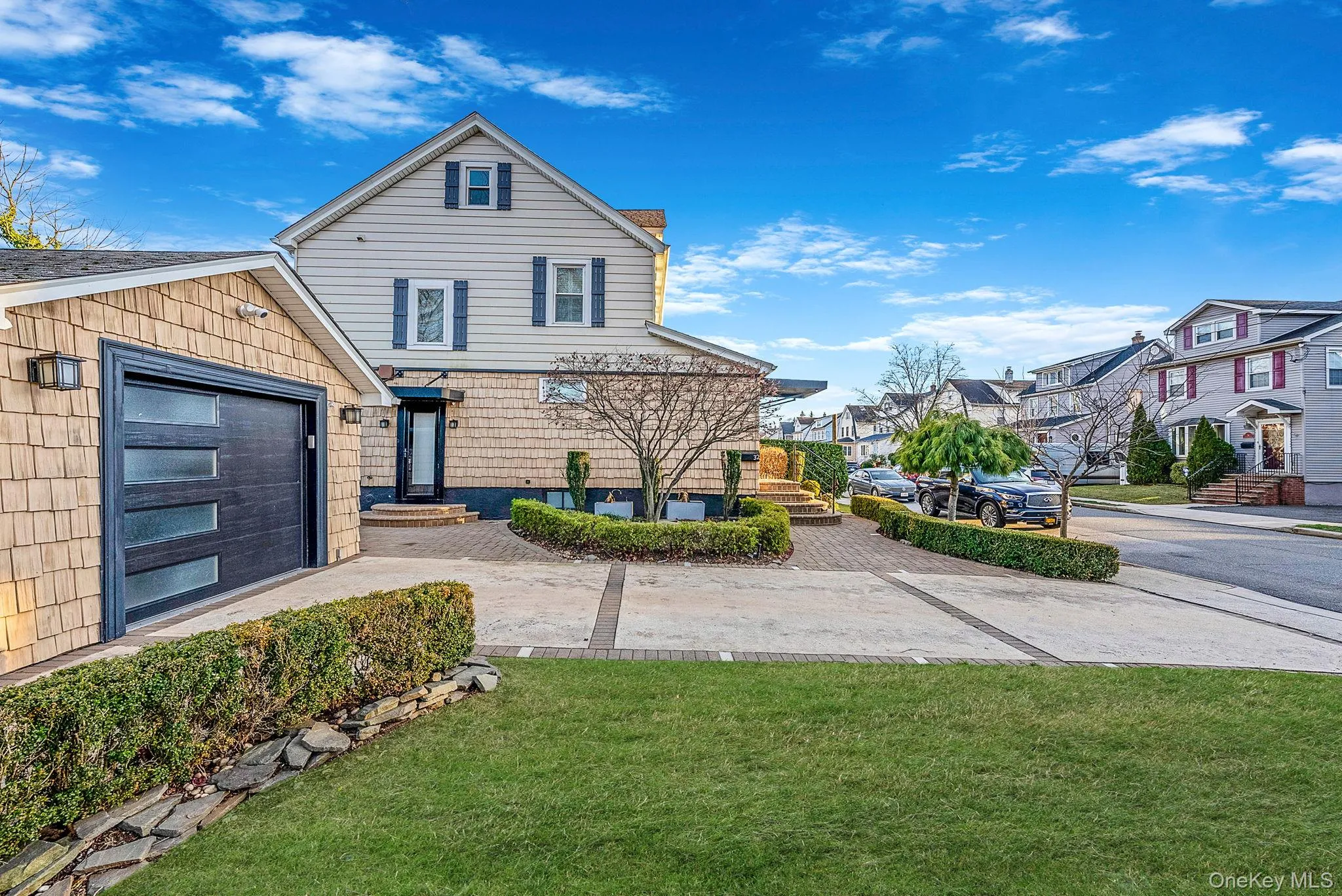 View of front of house featuring a front yard, a garage, and a residential view View of front of house featuring a front yard, a garage, and a residential view