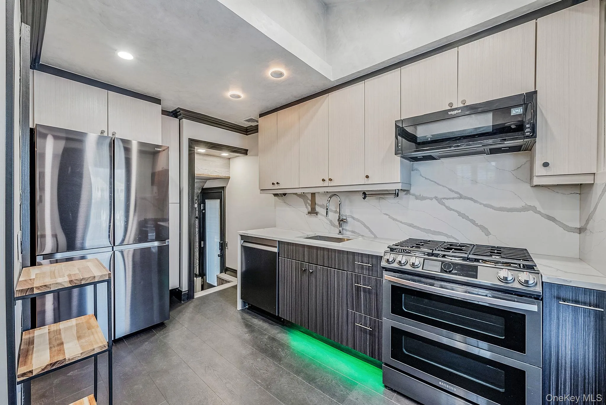 Kitchen featuring stainless steel appliances, ventilation hood, tasteful backsplash, light stone countertops, and recessed lighting Kitchen featuring stainless steel appliances, ventilation hood, tasteful backsplash, light stone countertops, and recessed lighting