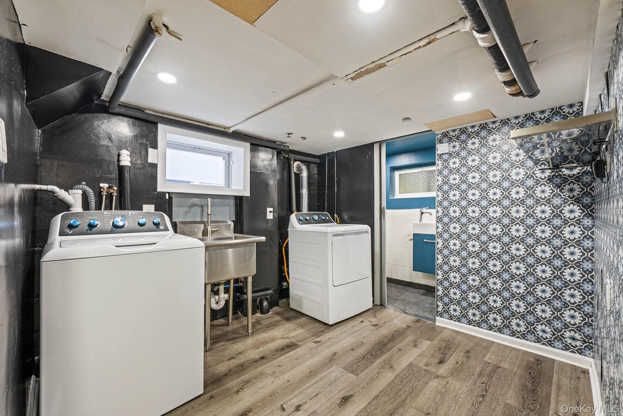Laundry area featuring light wood-style floors and washing machine and dryer Laundry area featuring light wood-style floors and washing machine and dryer