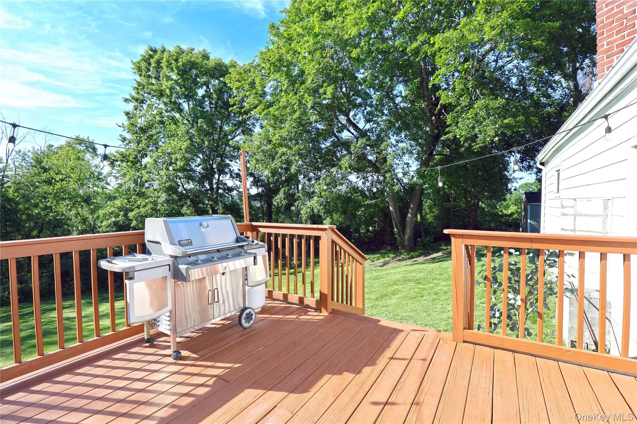 Spacious back deck with views of yard, field beyond and beautiful sunsets. Spacious back deck with views of yard, field beyond and beautiful sunsets.