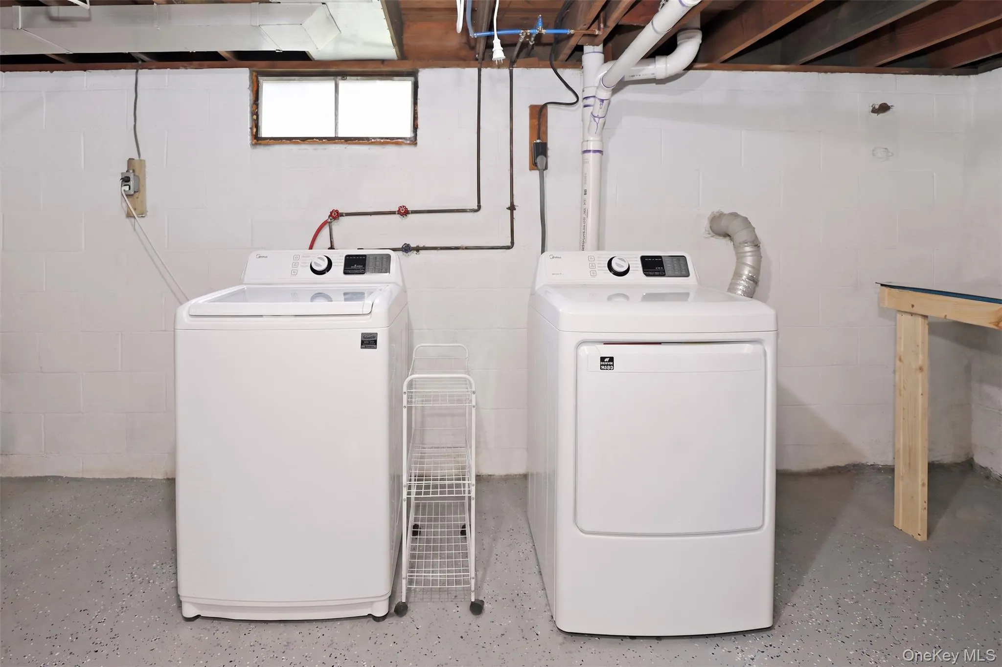 Laundry in full basement with updated flooring, gym space, storage & utilities. Laundry in full basement with updated flooring, gym space, storage & utilities.