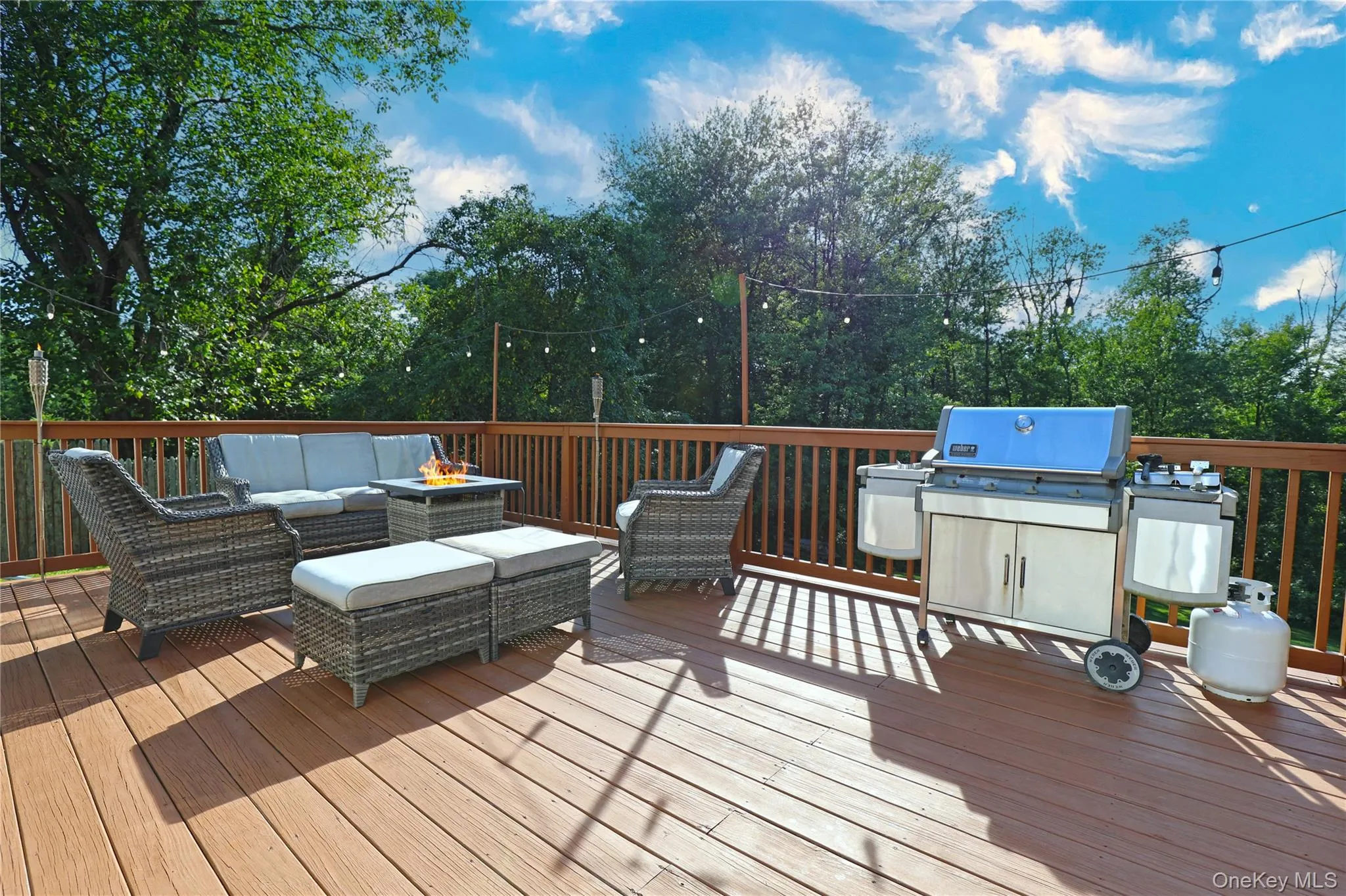 Spacious back deck with views of yard, field beyond and beautiful sunsets. Spacious back deck with views of yard, field beyond and beautiful sunsets.