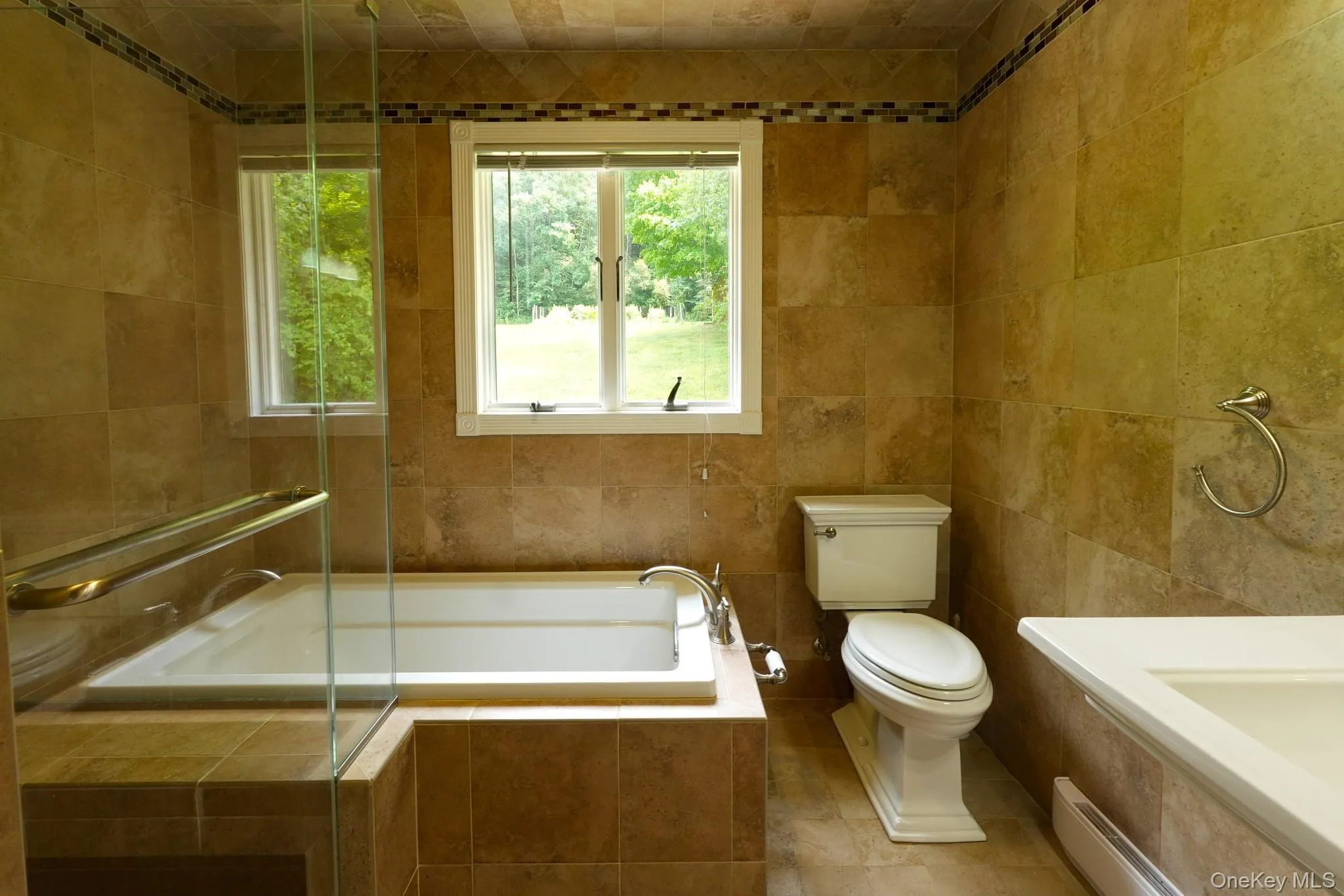 Tiled full bath with soaking tub. Tiled full bath with soaking tub.