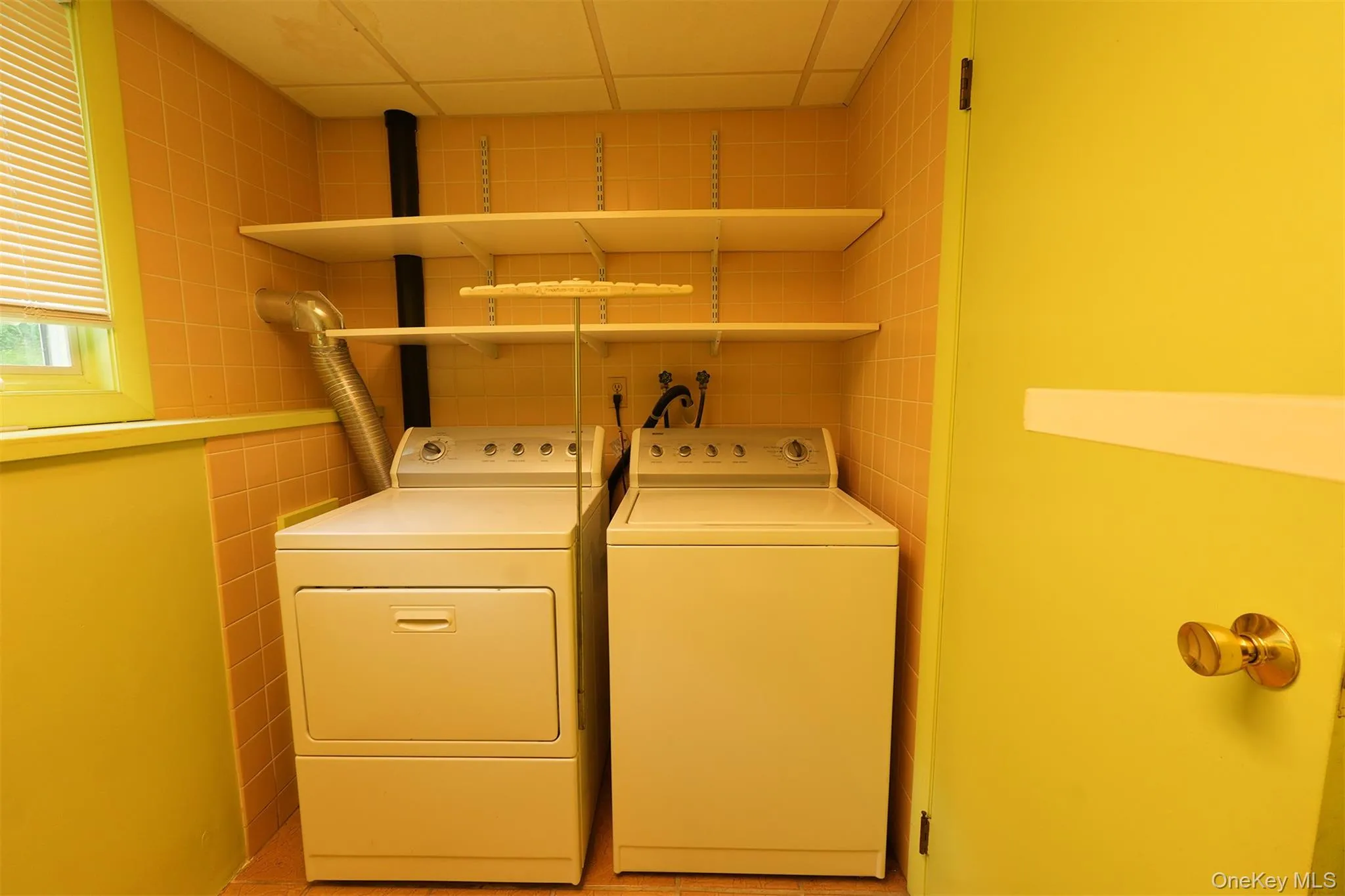 Bright, cheery Laundry area with shelves for storage. Bright, cheery Laundry area with shelves for storage.
