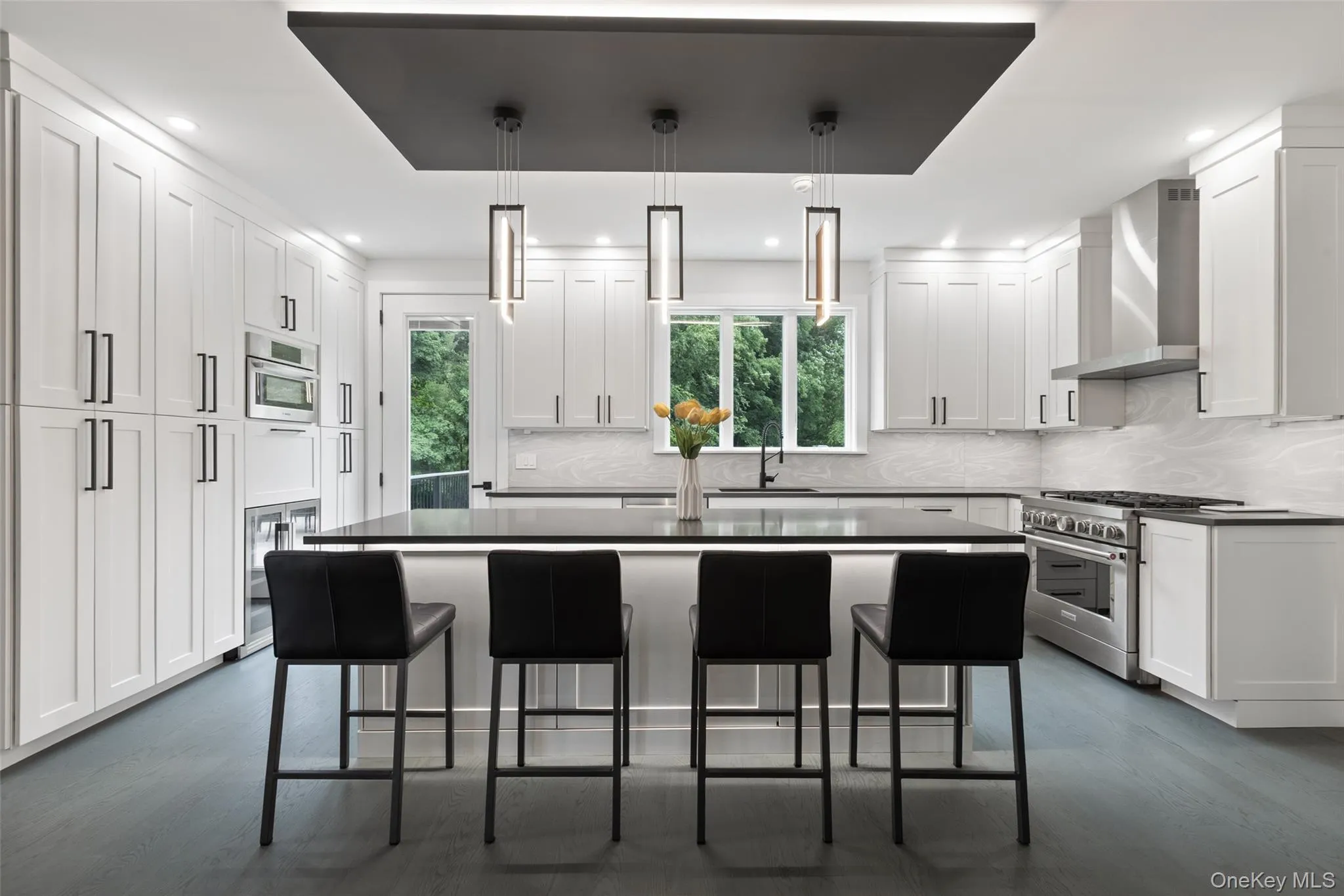 Kitchen with Quartz countertops, stainless steel appliances, wine fridge, and walk-in pantry Kitchen with Quartz countertops, stainless steel appliances, wine fridge, and walk-in pantry